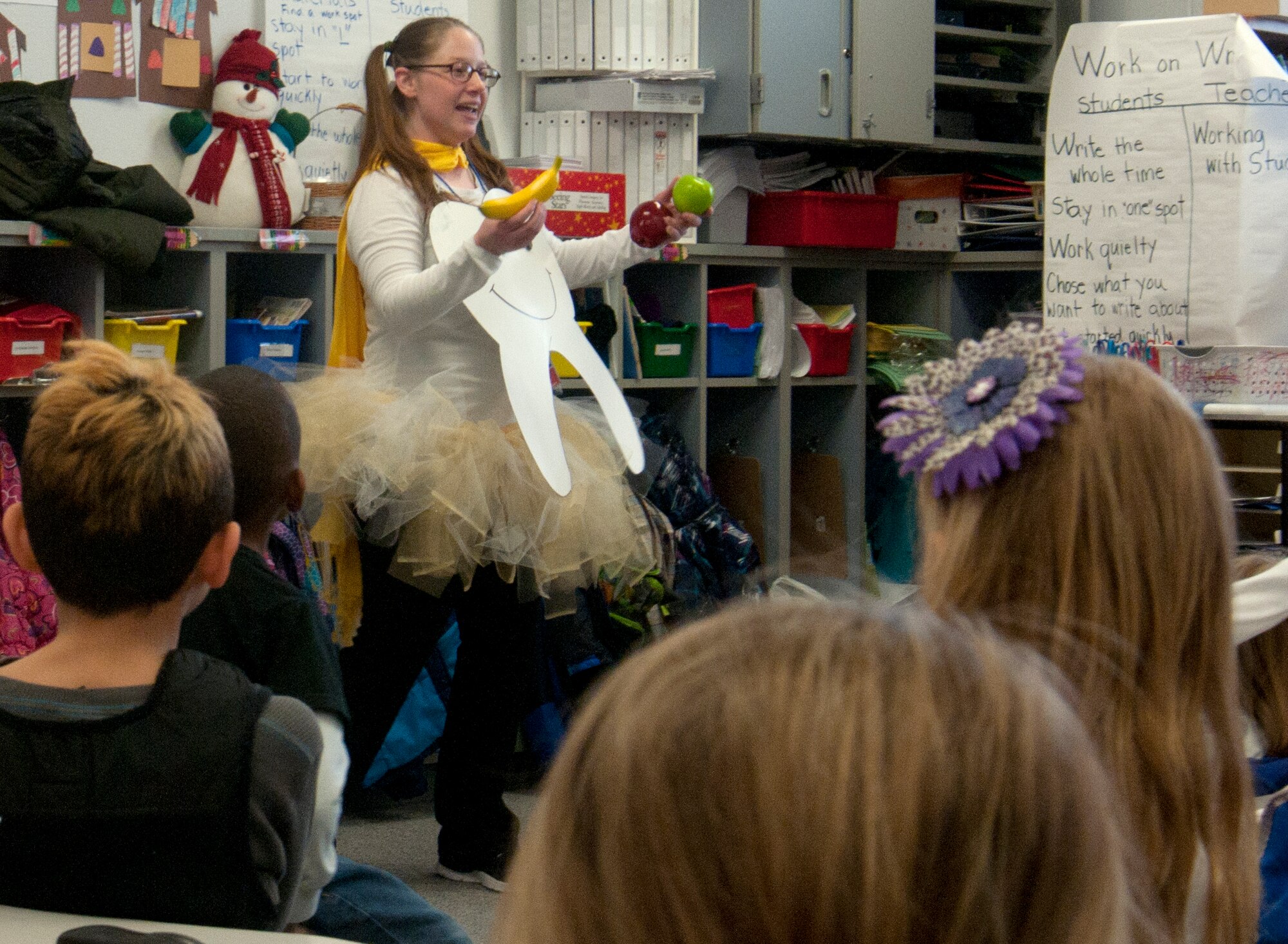 Staff Sgt. Sharon Palmer, 90th Medical Operations Squadron dental assistant, discusses which foods are better for dental health with Freedom Elementary School students Feb. 6, 2014. Palmer and other 90th MDOS Dental Flight Airmen visited the school in keeping with the spirit of Children’s Dental Health Month; they taught students proper ways to brush and floss their teeth and other dental care topics. (U.S. Air Force photo by Airman 1st Class Jason Wiese)