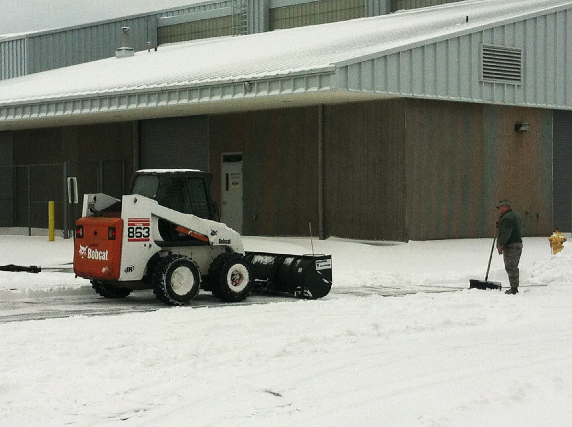 Airmen from the 142nd Fighter Wing Civil Engineer Squadron work to remove snow and ice from the Portland Air National Guard Base, Ore., Feb. 8, 2014.  The February Unit Training Assembly was cancelled, but a small group from the CES worked over the weekend to keep the base running and the alert mission operational during the winter storm that hit the Pacific Northwest region. (photo courtesy of Lt. Col. Jason Lay, 142nd Fighter Wing Civil Engineers)