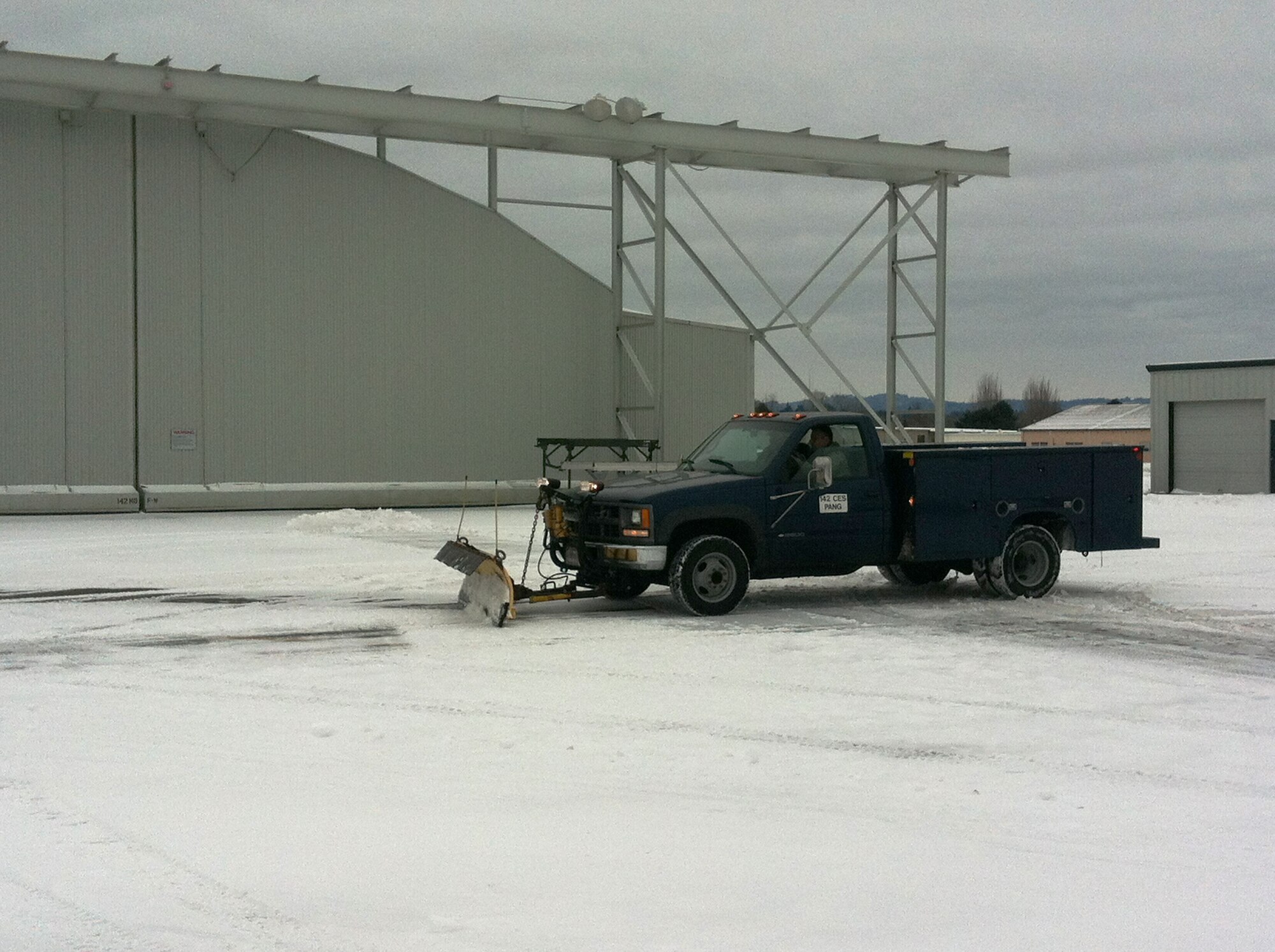 Airmen from the 142nd Fighter Wing Civil Engineer Squadron work to remove snow and ice from the Portland Air National Guard Base, Ore., Feb. 8, 2014.  The February Unit Training Assembly was cancelled, but a small group from the CES worked over the weekend to keep the base running and the alert mission operational during the winter storm that hit the Pacific Northwest region. (photo courtesy of Lt. Col. Jason Lay, 142nd Fighter Wing Civil Engineers)