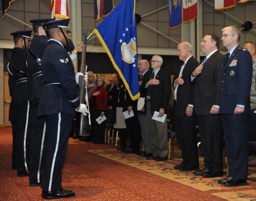 Airmen from McConnell and local dignitaries respect the colors during the 20th Anniversary of 22nd ARW Jan. 7, 2013, at McConnell Air Force Base, Kan. The 22nd ARW’s primary mission has been to provide global reach by conducting air refueling and airlift where and when needed since 1994. (U.S. Air Force photo/Senior Airman Maurice A. Hodges)