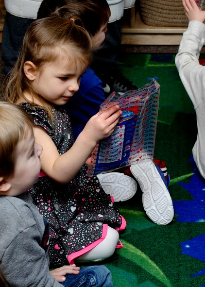 Alexis Peterson, Child Development Center preschool student, looks through a dental health kit during a class in the CDC at Ellsworth Air Force Base, S.D., Feb. 6, 2014. In an effort to promote healthy oral hygiene, Airmen of the 28th Medical Operations Squadron gave each child in the CDC a dental health kit that contained a number of items including a toothbrush, toothpaste and dental floss. (U.S. Air Force photo by Senior Airman Anania Tekurio/Released)