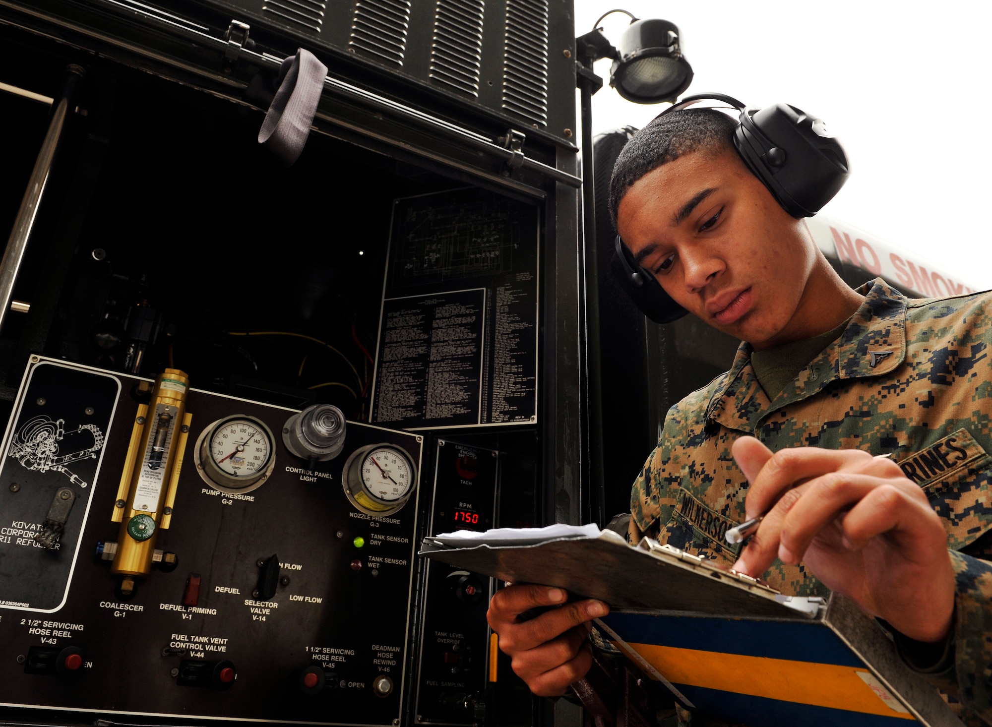 U.S. Marine Corps Lance Cpl. Derrick Wilkerson, 9th Engineer Support Battalion bulk fuel technician, logs a consolidation sheet during a Field Exchange Program on Kadena Air Base, Japan, Feb. 6, 2014. The 18th Logistics Readiness Squadron provided training to Marines to teach bulk refueling techniques, lab analysis and issuance of aviation fuels. (U.S. Air Force photo by Naoto Anazawa)