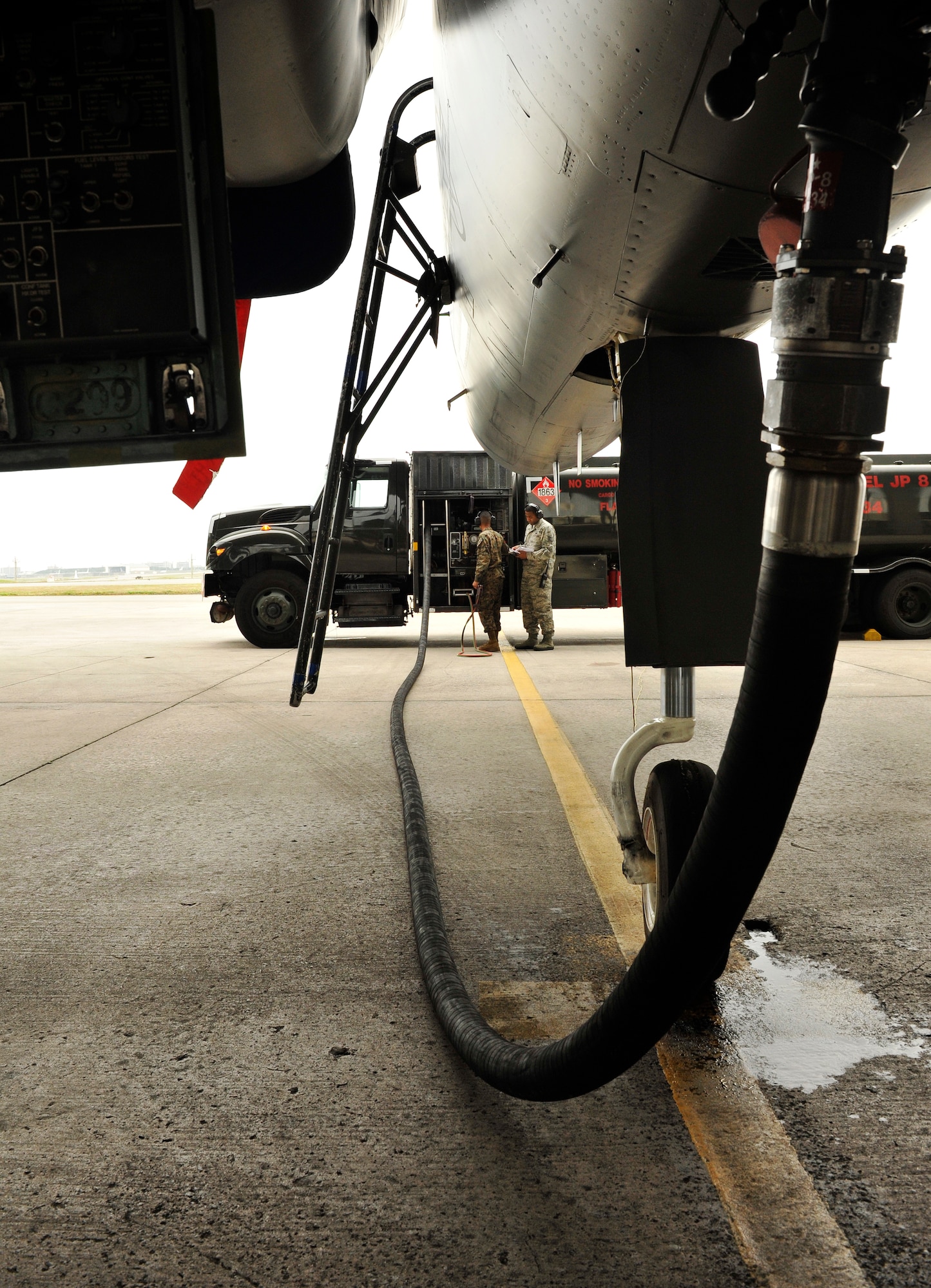 U.S. Marine Corps Lance Cpl. Derrick Wilkerson, 9th Engineer Support Battalion bulk fuel technician, fills an F-15 Eagle's fuel tank under the supervision of U.S. Air Force Tech. Sgt. Jimmy Turner, 18th Logistics Readiness Squadron NCO in charge of fuel distribution, during the Field Exchange Program on Kadena Air Base, Japan, Feb. 6, 2014. The 18th LRS took part in the trial program in which five Marines rotate for six months here and participate in training as part of a trial program to educate Marine bulk refueling technicians on airfield procedures to include receipt, transfer, lab analysis and issuance of aviation fuels. (U.S. Air Force photo by Naoto Anazawa)