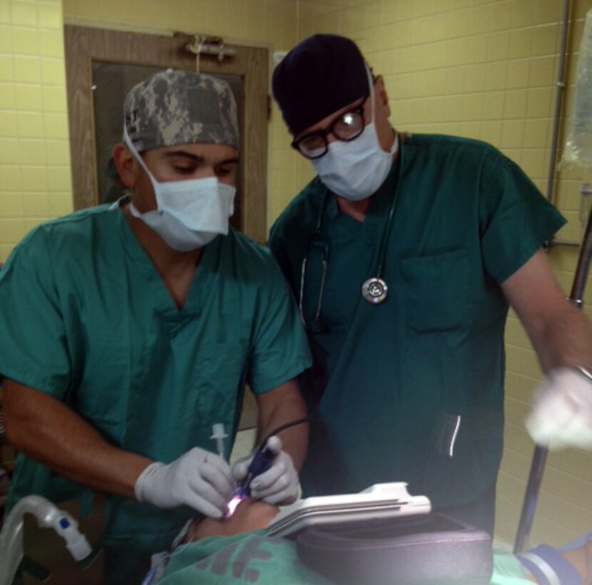 Members of Joint Task Force-Bravo's Mobile Surgical Team (MST) perform a surgical procedure on a patient at Hospital Escuela in Tegucigalpa, Honduras, Feb. 4, 2014.  The MST completed seven surgeries and the Task Force’s Emergency Medicine Team (EMT) saw over 30 cases during a Medical Readiness Training Exercise (MEDRETE) at the hospital, February 3-6.  (Courtesy photo)