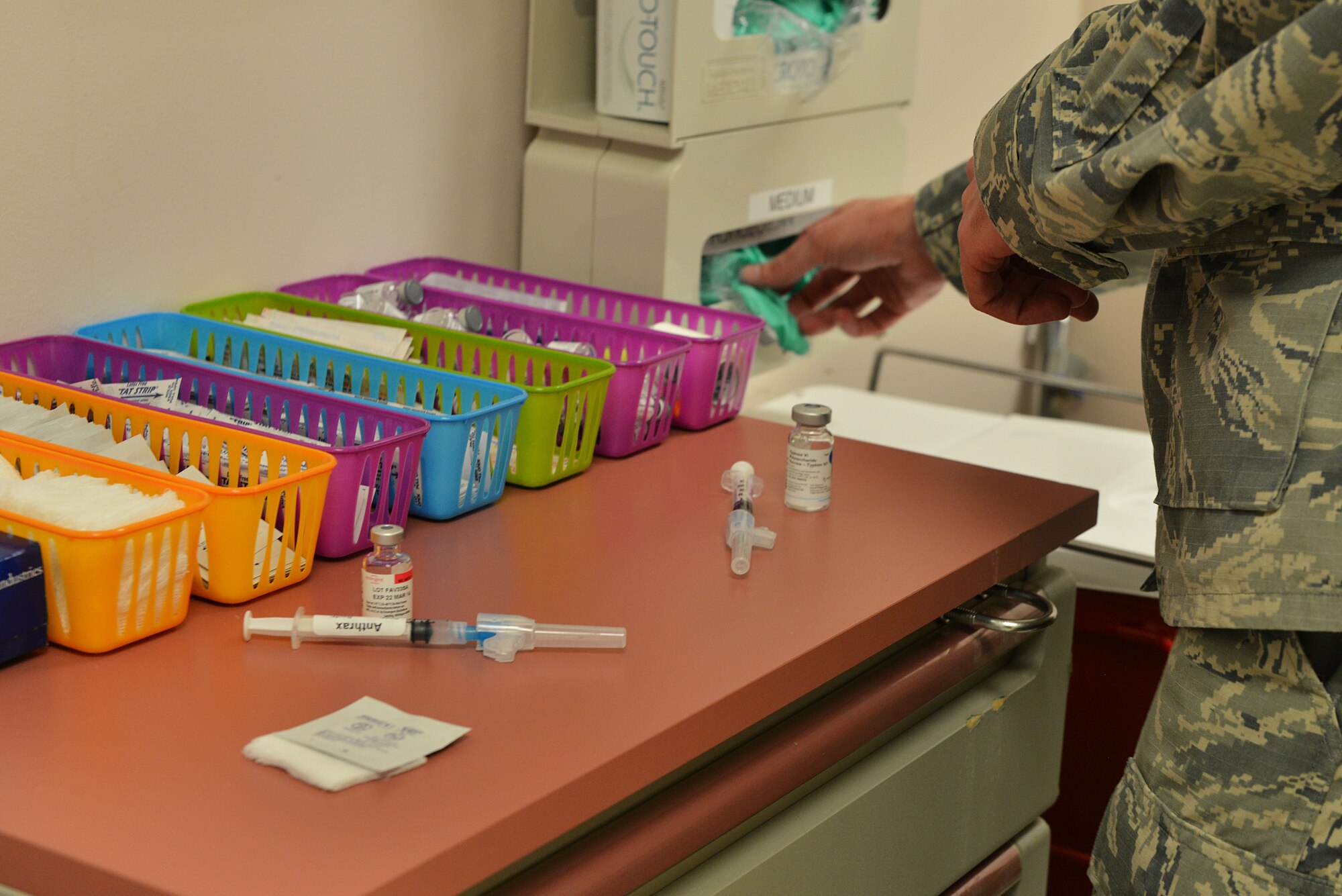 U.S. Air Force Tech. Sgt. Richard Sangston, 20th Medical Group NCO in charge of immunization, prepares to administer a vaccination at Shaw Air Force Base, S.C., Feb. 5, 2014.  Several supplies are used in the process of giving a vaccination such as a syringe, vile, alcohol wipe, rubber gloves and band-aids. (U.S. Air Force photo by Airman 1st Class Jensen Stidham/Released)