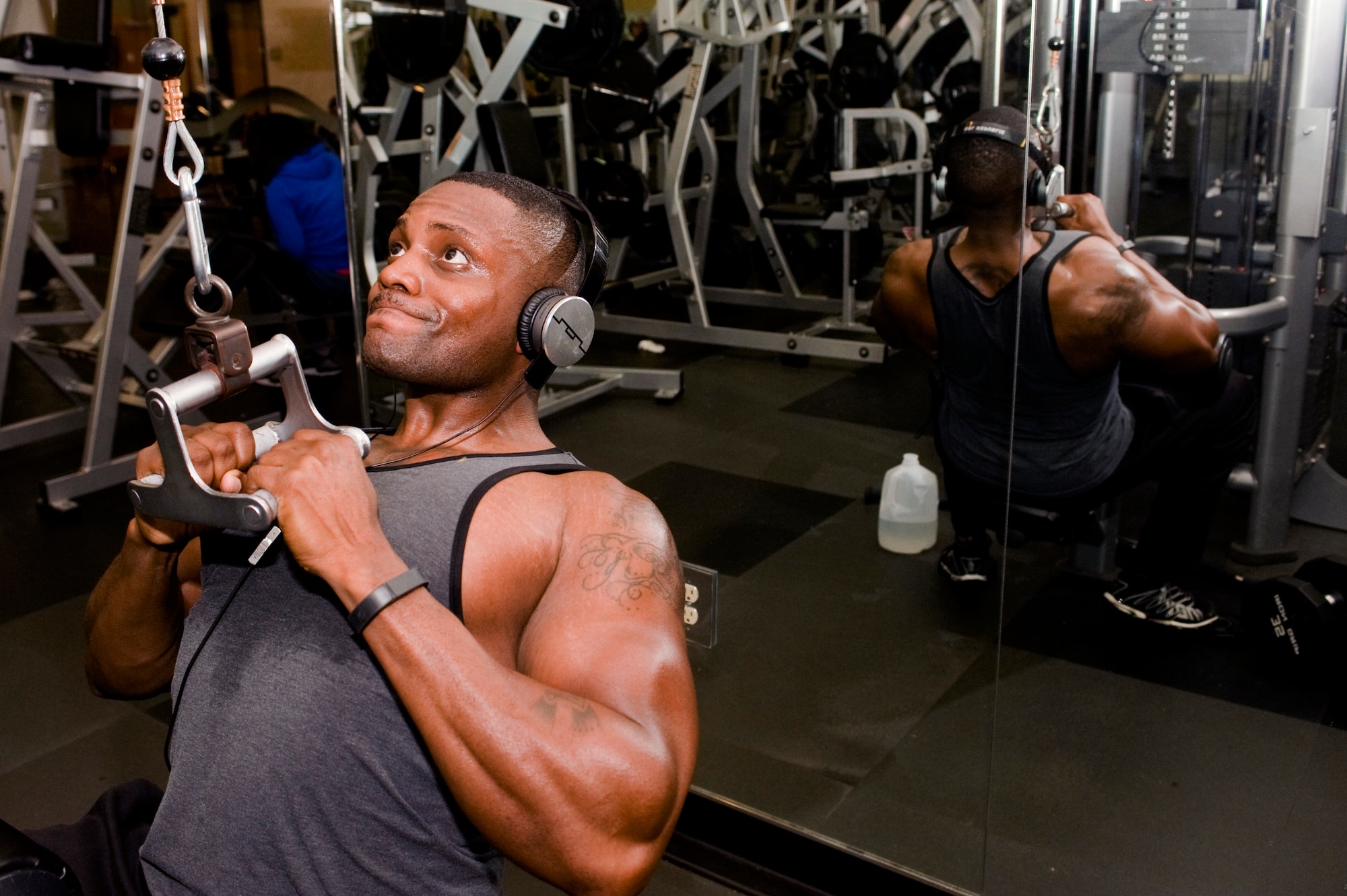 U.S. Air Force Staff Sgt. Damar Turner, 633rd Force Support Squadron Airman Leadership School instructor, performs lat pull-downs at the Shellbank Fitness Center at Langley Air Force Base, Va., Jan. 15, 2014. Turner trains year-round to compete in body building. Turner is a native of Queens, N.Y. (U.S. Air Force photo by Staff Sgt. Stephanie R. Plichta/Released) 