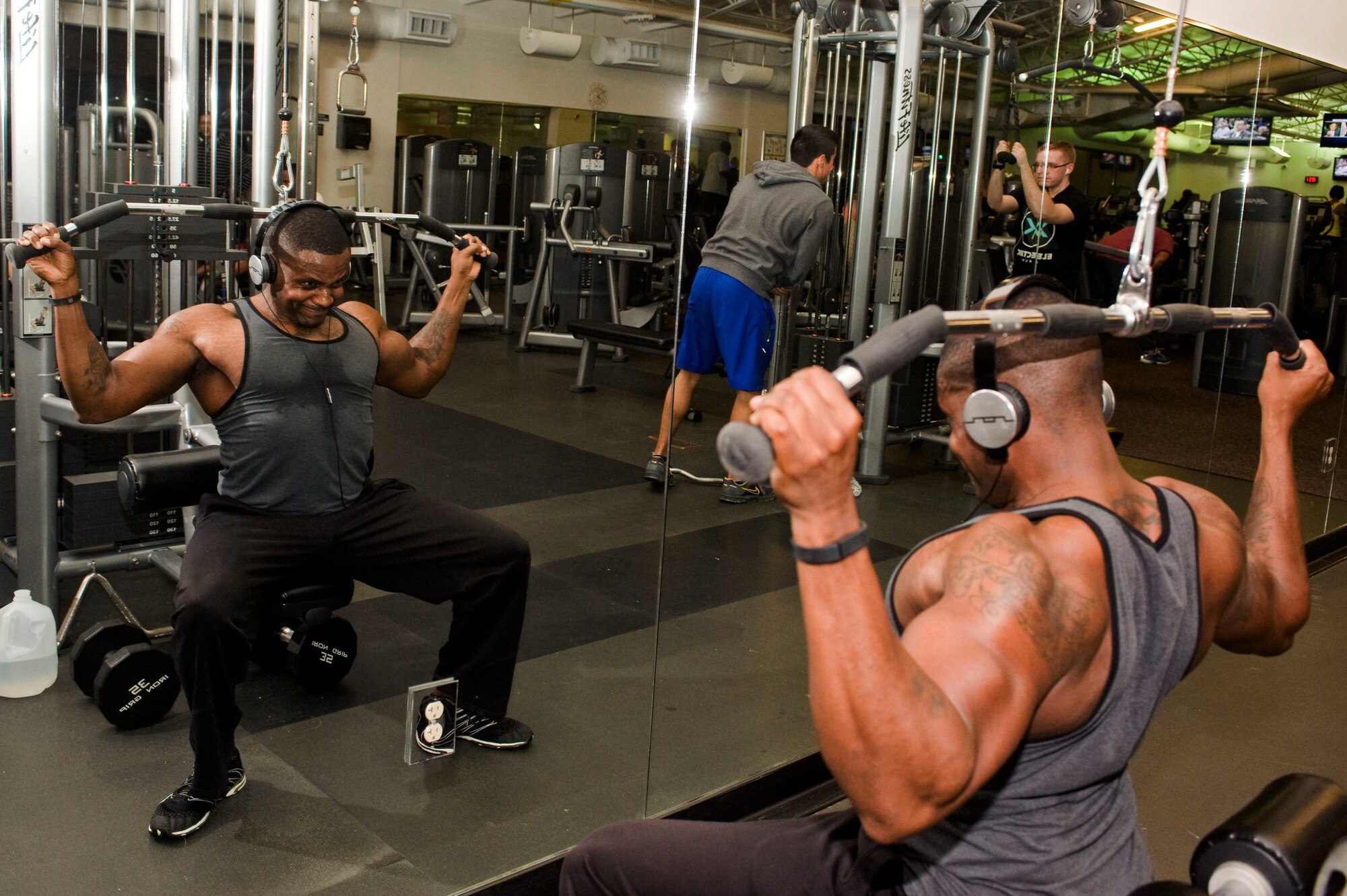U.S. Air Force Staff Sgt. Damar Turner, 633rd Force Support Squadron Airman Leadership School instructor, performs lat pull-downs in Shellbank Fitness Center at Langley Air Force Base, Va., Jan. 15, 2014. Turner performs twice-daily workouts, focusing on cardio and weight lifting. Turner is a native of Queens, N.Y. (U.S. Air Force photo by Staff Sgt. Stephanie R. Plichta/Released)