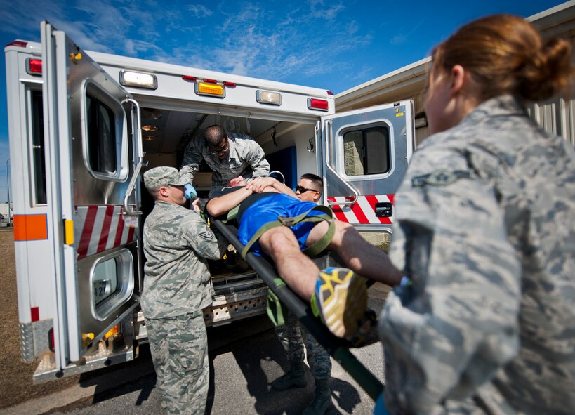 Emergency medical technicians move a victim into an ambulance after a simulated bomb exploded injuring more than 30 people during a mass casualty exercise Feb. 5 at Eglin Air Force Base, Fla.  The simulated victims were moved to a safe area, decontaminated and then treated by 96th Medical Group personnel.  (U.S. Air Force photo/Samuel King Jr.)