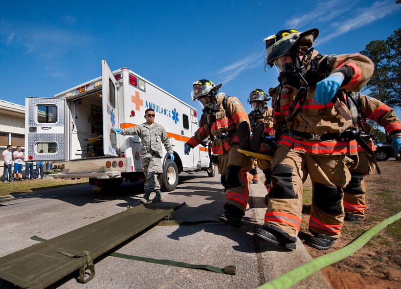 96th Test Wing firefighters carry a victim to an ambulance after a simulated bomb exploded injuring more than 30 people during a mass casualty exercise Feb. 5 at Eglin Air Force Base, Fla.  The simulated victims were moved to a safe area, decontaminated and then treated by 96th Medical Group personnel.  (U.S. Air Force photo/Samuel King Jr.)