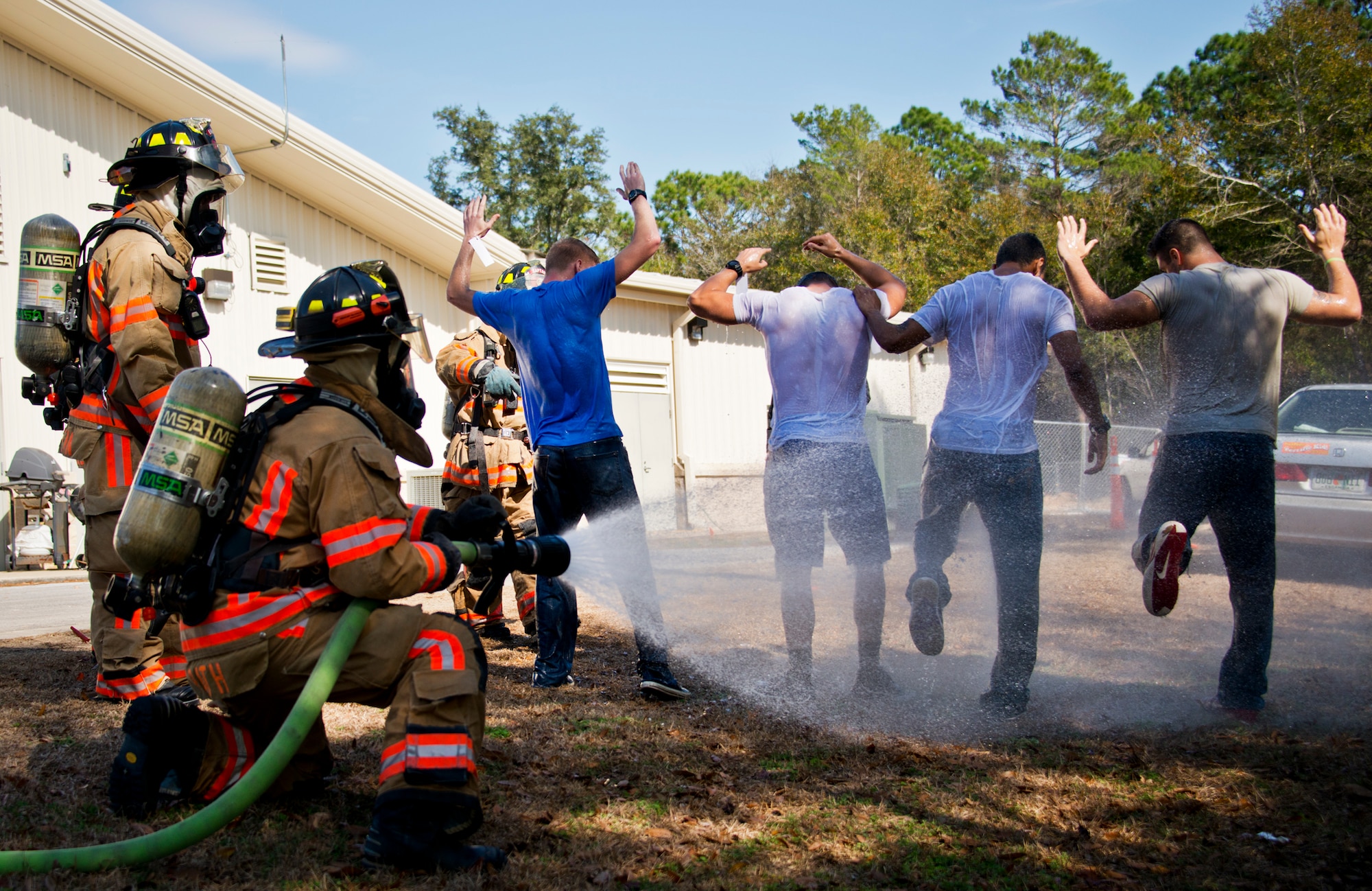 A 96th Test Wing firefighter decontaminates victims affected by a simulated bomb exploded injuring more than 30 people during a mass casualty exercise Feb. 5 at Eglin Air Force Base, Fla.  The simulated victims were moved to a safe area, decontaminated and then treated by 96th Medical Group personnel.  (U.S. Air Force photo/Samuel King Jr.)