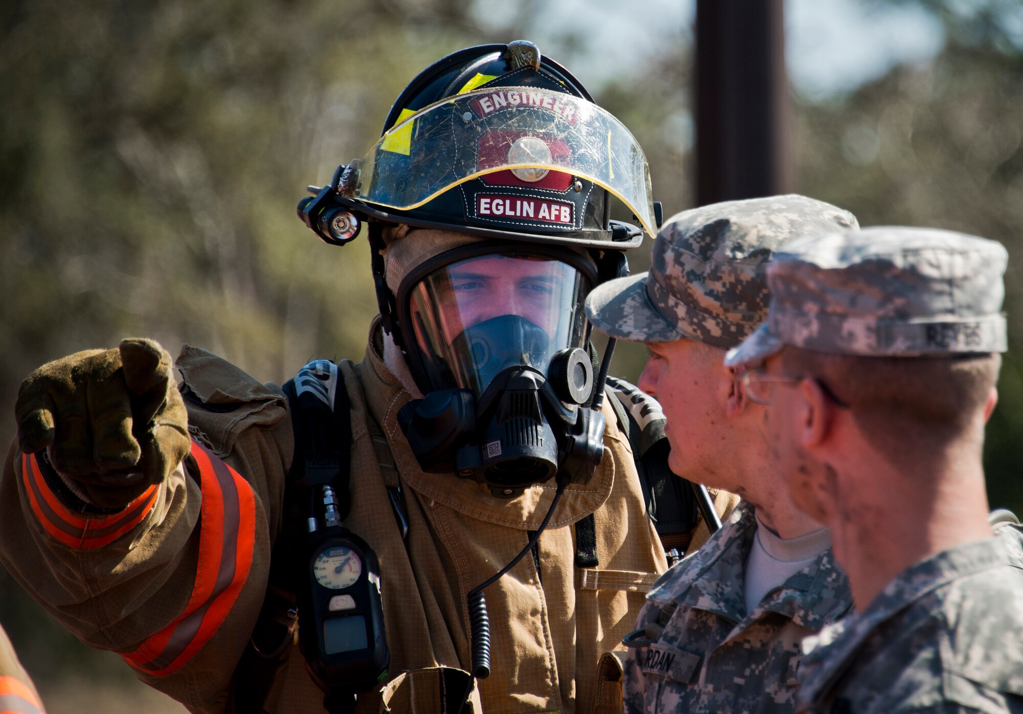 A 96th Test Wing firefighter directs Soldiers were to move to after a simulated bomb exploded injuring more than 30 people during a mass casualty exercise Feb. 5 at Eglin Air Force Base, Fla.  The simulated victims were moved to a safe area, decontaminated and then treated by 96th Medical Group personnel.  (U.S. Air Force photo/Samuel King Jr.)