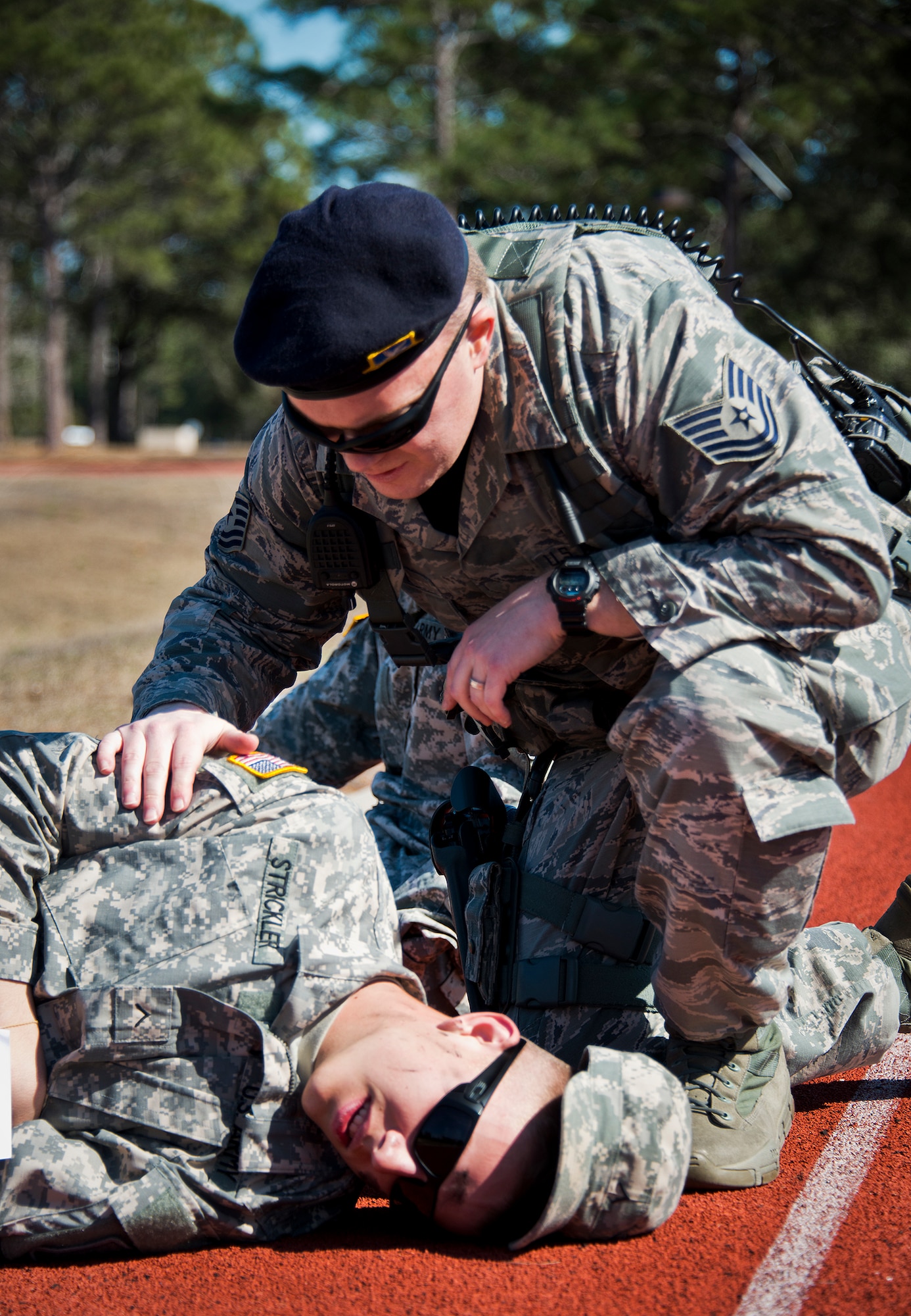 Tech. Sgt. Christopher Nulty, a 96th Security Forces Airman, checks on an Soldier after a simulated bomb exploded injuring more than 30 people during a mass casualty exercise Feb. 5 at Eglin Air Force Base, Fla.  The simulated victims were moved to a safe area, decontaminated and then treated by 96th Medical Group personnel.  (U.S. Air Force photo/Samuel King Jr.)