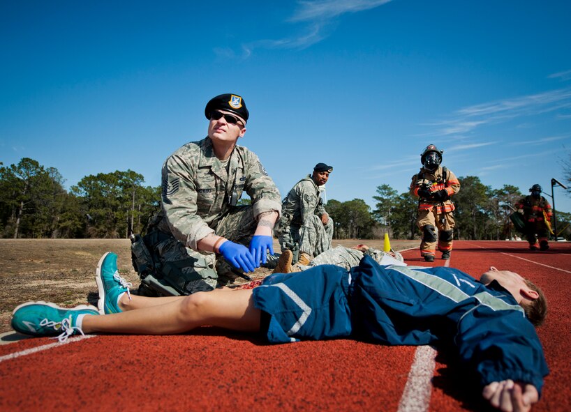 Tech. Sgt. Joel Wahowski, a 96th Security Forces Airman, waits for assistance from firefighters after a simulated bomb exploded injuring more than 30 people during a mass casualty exercise Feb. 5 at Eglin Air Force Base, Fla.  The simulated victims were moved to a safe area, decontaminated then treated by 96th Medical Group personnel.  (U.S. Air Force photo/Samuel King Jr.)