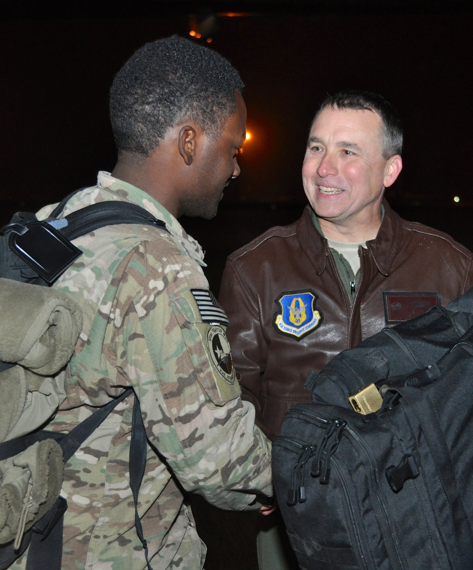 Col. John Breazeale, 301st Fighter Wing commander, welcomes returning Airmen from their recent deployment to Afghanistan. Reservists from the 301st Fighter Wing returned to chilly temperatures and a warm welcome home. Family members and friends displayed signs anticipating arrival of those deployed in support of Operation Enduring Freedom. (U.S. Air Force photo/MSgt Josh Woods)