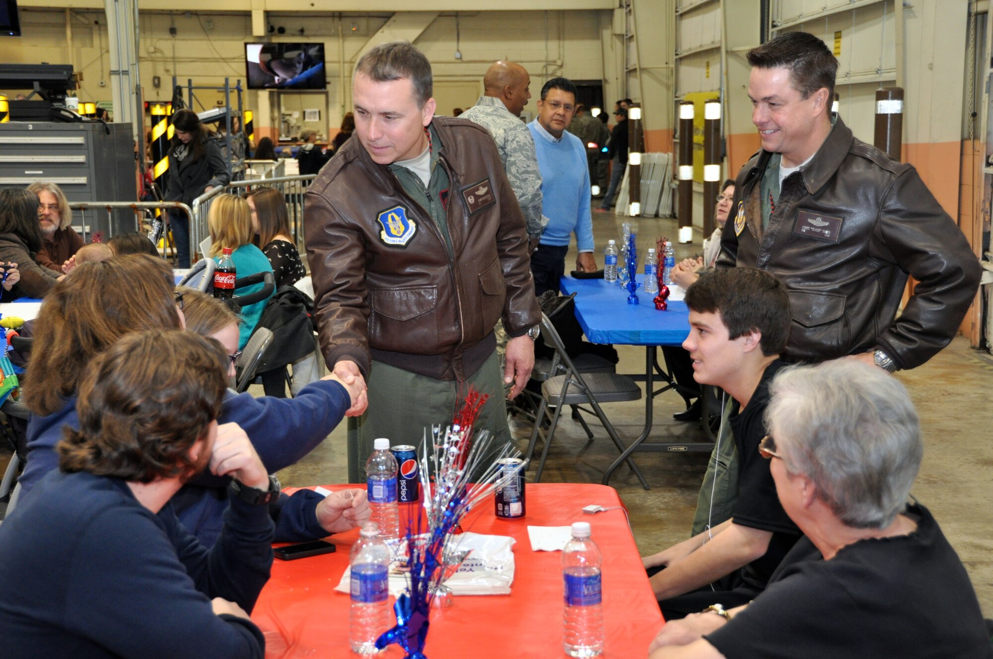 (center) Col. John Breazeale, 301st Fighter Wing commander, and (right standing) Col Chris Yancy, 301st FW vice commander, visit with families before the aircraft arrived carrying nearly 300 Air Force Reserve Airmen. Reservists from the 301st and 482nd Fighter Wing returned to chilly temperatures and a warm welcome home. Family members and friends displayed signs anticipating their loved-one's arrival from Afghanistan where they were deployed in support of Operation Enduring Freedom. (U.S. Air Force photo/MSgt Josh Woods)