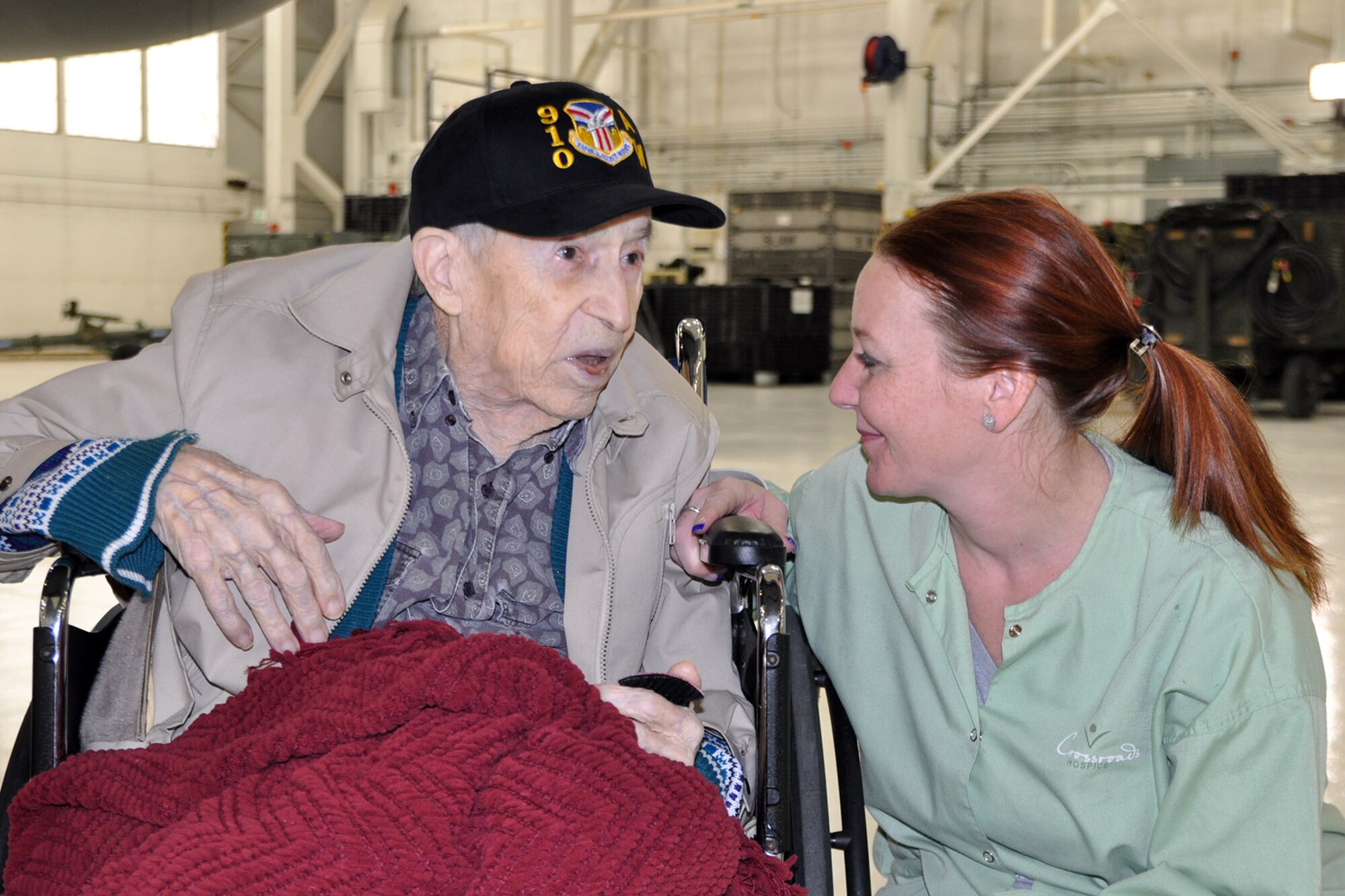 YOUNGSTOWN AIR RESERVE STATION, Ohio – Mr. Edward Hitesman, a World War II Army Air Corps veteran, talks with Melissa Goudy, his nursing assistant, during a special tour here, Feb. 2, 2014. Hitesman and his family visited YARS at the request of Crossroads Hospice in Green, Ohio as part of the facility’s Gift of a Day program. The program is designed to ask terminal patients, “How do you envision your perfect day?” The hospice then strives to create that image and make it a special day for the patient and their family. The 94-year-old veteran’s idea of a “perfect day” was to spend it at YARS and with the Citizen Airmen of the Air Force Reserve’s 910th Airlift Wing. U.S. Air Force photo by Master Sgt. Bob Barko Jr.
