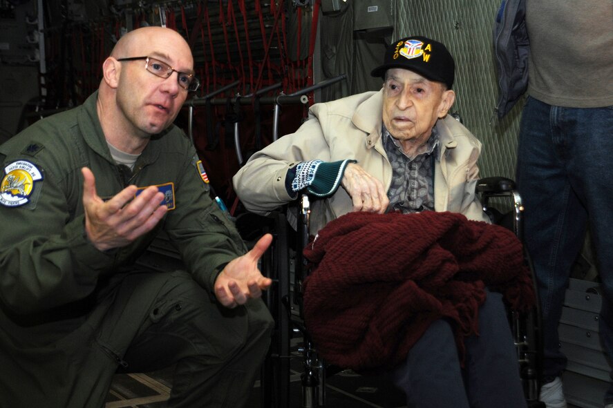 YOUNGSTOWN AIR RESERVE STATION, Ohio – Air Force Reserve Lt. Col. John “Chinky” Kochansky, assistant director of operations for the 910th Airlift Wing’s 757th Airlift Squadron, talks with Mr. Edward Hitesman, a World War II Army Air Corps veteran, and members of the veteran’s family during a special tour here, Feb. 2, 2014. Hitesman’s group visited YARS at the request of Crossroads Hospice in Green, Ohio as part of the facility’s Gift of a Day program. The program is designed to ask terminal patients, “How do you envision your perfect day?” The hospice then strives to create that image and make it a special day for the patient and their family. The 94-year-old veteran’s idea of a “perfect day” was to spend it at YARS and with the Service members assigned here. U.S. Air Force photo by Master Sgt. Bob Barko Jr.