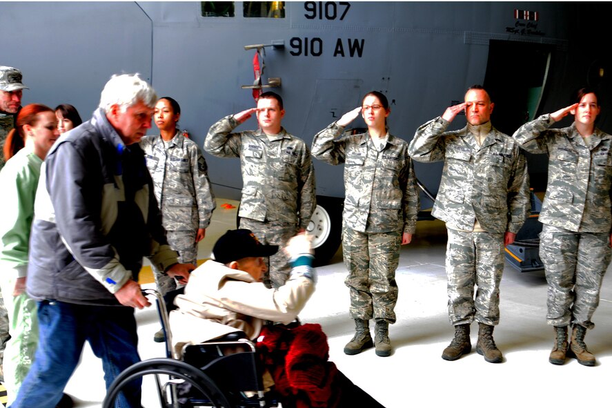 YOUNGSTOWN AIR RESERVE STATION, Ohio – Mr. Edward Hitesman, a World War II Army Air Corps veteran, returns the salutes of an honor cordon comprised of more than 60 Citizen Airmen assigned to the Air Force Reserve’s 910th Airlift Wing during a special tour here, Feb. 2, 2014. Hitesman and his family visited YARS at the request of Crossroads Hospice in Green, Ohio as part of the facility’s Gift of a Day program. The program is designed to ask terminal patients, “How do you envision your perfect day?” The hospice then strives to create that image and make it a special day for the patient and their family. The 94-year-old veteran’s idea of a “perfect day” was to spend it at YARS and with the Service members assigned here. U.S. Air Force photo by Senior Airman Rachel Kocin.