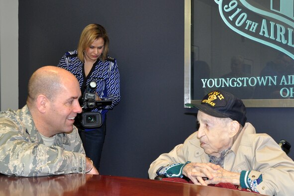 YOUNGSTOWN AIR RESERVE STATION, Ohio – Air Force Reserve Col. James Dignan, 910th Airlift Wing commander, talks with Mr. Edward Hitesman, a World War II Army Air Corps veteran, during a special tour here, Feb. 2, 2014. Hitesman and his family visited YARS at the request of Crossroads Hospice in Green, Ohio as part of the facility’s Gift of a Day program. The program is designed to ask terminal patients, “How do you envision your perfect day?” The hospice then strives to create that image and make it a special day for the patient and their family. The 94-year-old veteran’s idea of a “perfect day” was to spend it at YARS and with the Citizen Airmen of the 910th Airlift Wing. U.S. Air Force photo by Master Sgt. Bob Barko Jr.
