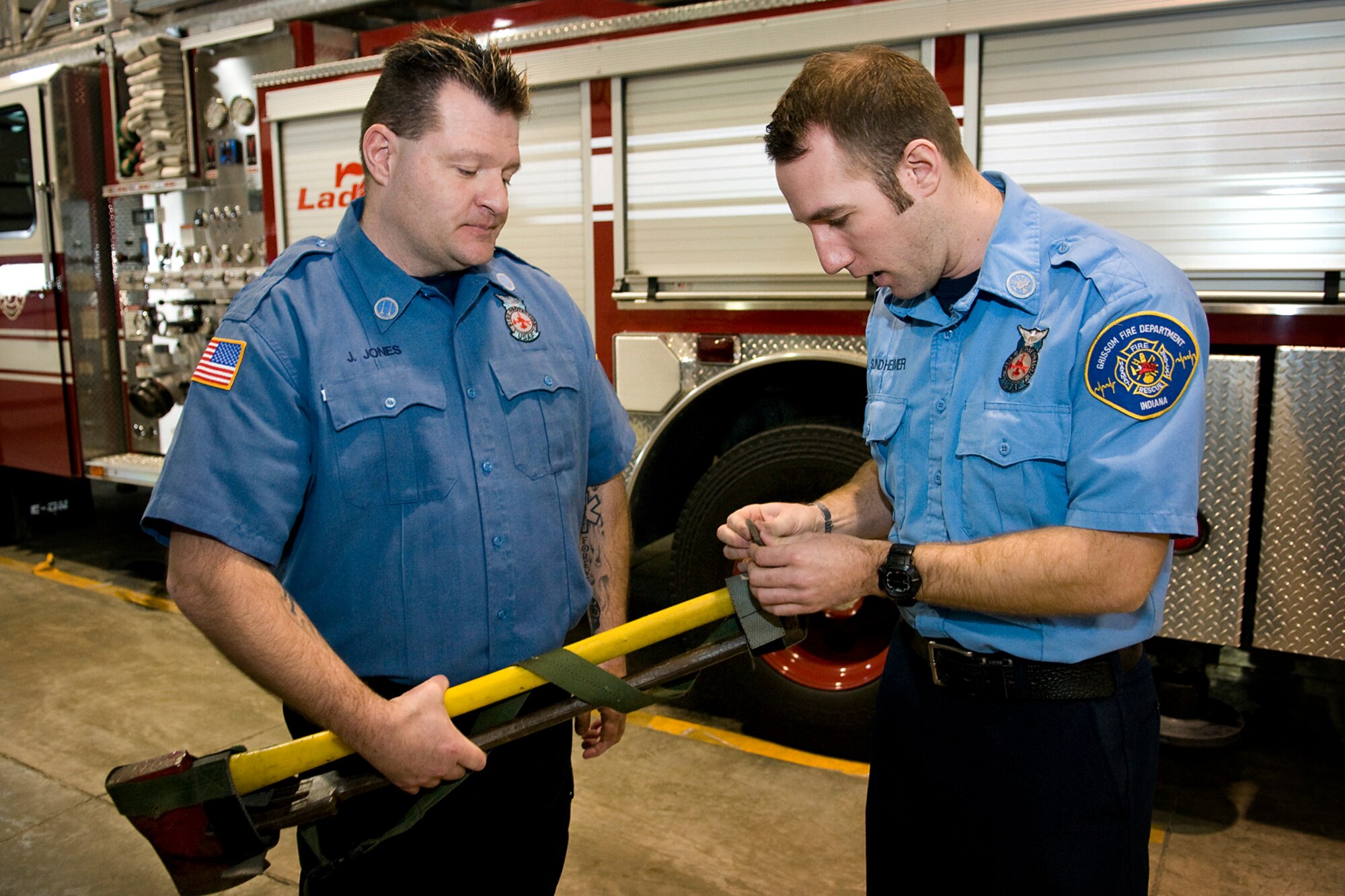 Capt. James Jones, left, and Aaron Sundheimer, both Grissom Fire Department firefighters assigned to GFD's Rescue 5, discuss the tools they use when responding to a fire at Grissom Air Reserve Base, Ind., Jan. 15, 2014. Jones and Sundheimer were recently honored for their heroic actions on the night of Aug. 25, 2012, with Department of Defense Emergency Services Heroism awards. (U.S. Air force photo/Tech. Sgt. Mark R. W. Orders-Woempner)
