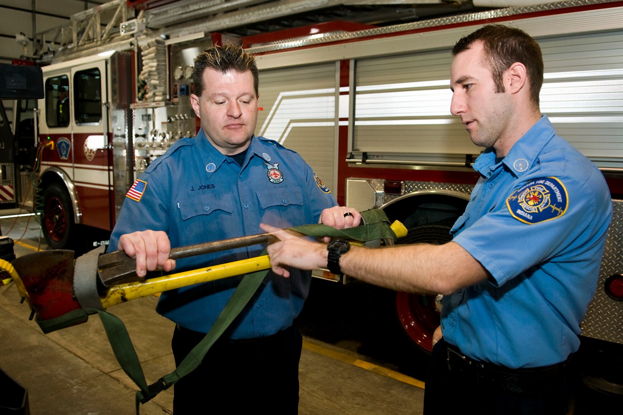 Capt. James Jones, left, and Aaron Sundheimer, both Grissom Fire Department firefighters assigned to GFD's Rescue 5, discuss the tools they use when responding to a fire at Grissom Air Reserve Base, Ind., Jan. 15, 2014. Jones and Sundheimer were recently honored for their heroic actions on the night of Aug. 25, 2012, with Department of Defense Emergency Services Heroism awards. (U.S. Air force photo/Tech. Sgt. Mark R. W. Orders-Woempner)

