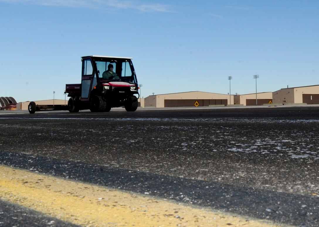 Master Sgt. Lance Stephenson, 28th Bomb Wing Foreign Object Debris program manager, drives the FOD Mule across the flight line at Ellsworth Air Force Base, S.D., Jan. 31, 2014. Stephenson conducts daily FOD checks on the flightline to ensure a safe work environment and prevent damage to aircraft and equipment. (U.S. Air Force photo by Senior Airman Anania Tekurio/Released)