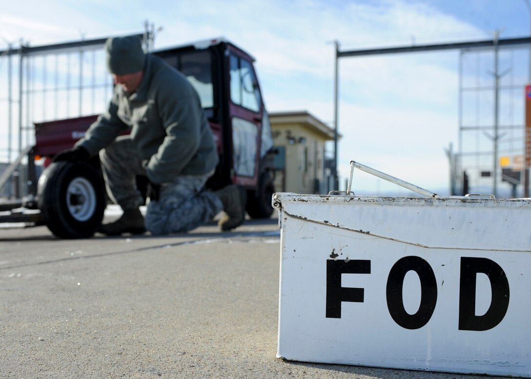 Master Sgt. Lance Stephenson, 28th Bomb Wing Foreign Object Debris program manager, inspects the FOD Mule prior to driving it onto the flight line at Ellsworth Air Force Base, S.D., Jan. 31, 2014. The FOD program is designed to eliminate any foreign objects from the flightline that can cause damage to aircraft and equipment. (U.S. Air Force photo by Senior Airman Anania Tekurio/Released)