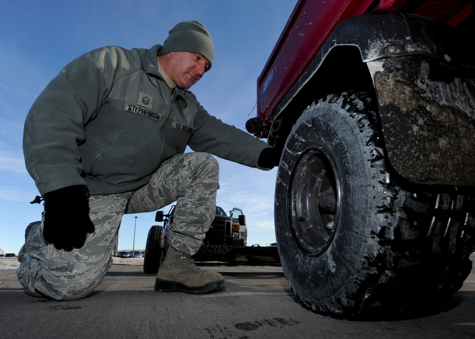 Master Sgt. Lance Stephenson, 28th Bomb Wing Foreign Object Debris program manager, checks the tires of the FOD Mule for FOD at Ellsworth Air Force Base, S.D., Jan. 31, 2014. Prior to driving onto the flight line, all vehicles must be inspected for FOD to ensure safety and prevent damage to aircraft. (U.S. Air Force photo by Senior Airman Anania Tekurio/Released)