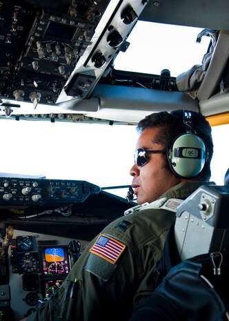 U.S. Air Force Capt. Tristen Wright, 92nd Air Refueling Squadron co-pilot, talks with the pilot of a KC-135 Stratotanker assigned to the 92nd Air Refueling Wing from Fairchild Air Force Base, Wash. during Red Flag 14-1 over the Nevada Test and Training Range Feb. 6, 2014. Red Flag, hosted at Nellis AFB, Nev., is a valuable training opportunity for aircrews to experience realistic combat scenarios in a controlled environment. (U.S. Air Force photo by Airman 1st Class Thomas Spangler)