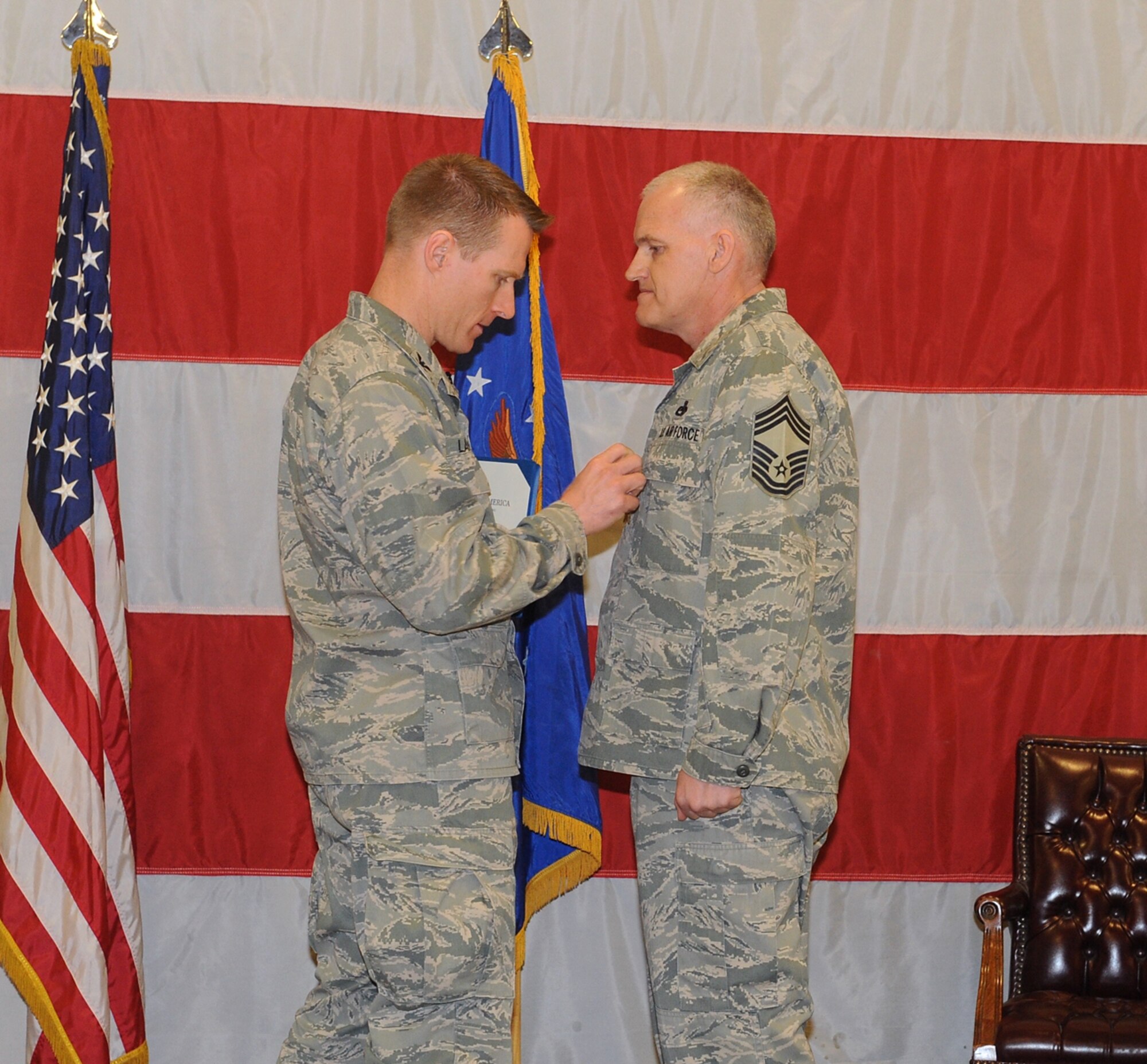 Chief Master Sgt. Ronald Haire, 388th Equipment Maintenance Squadron maintenance superintendent, is awarded the Bronze Star Medal by Col. Lance Landrum, 388th Fighter Wing commander, at the wing's monthly award and promotion ceremony Jan. 31. (U.S. Air Force photo by Alex R. Lloyd)