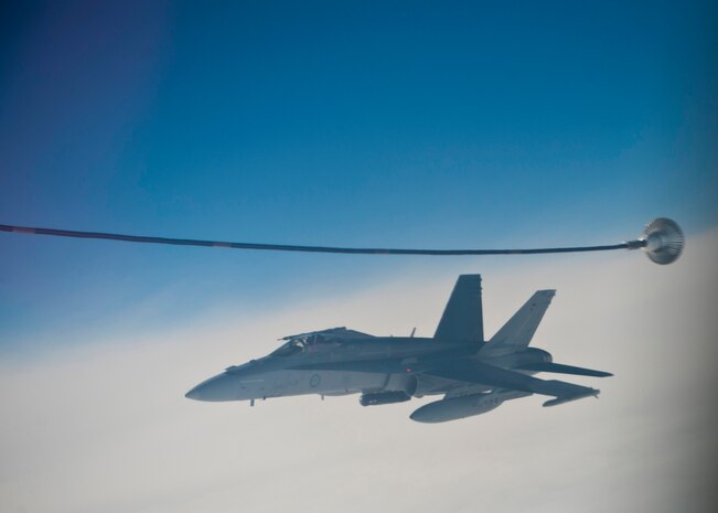 A Royal Australian Air Force F/A-18 from No. 77 Royal Australian Air Force Base Williamtown, Australia, finishes mid-air refueling over the Nevada Test and Training Range during Red Flag 14-1 with a U.S. Air Force KC-135 Stratotanker assigned to the 92nd Air Refueling Wing from Fairchild Air Force Base, Wash., Feb. 6, 2014. Red Flag is an exercise hosted at Nellis Air Force Base, Nev., that gives Airmen an opportunity to experience realistic, stressful combat situations in a controlled environment to increase their ability to complete missions and safely return home. (U.S. Air Force photo by Airman 1st Class Thomas Spangler)