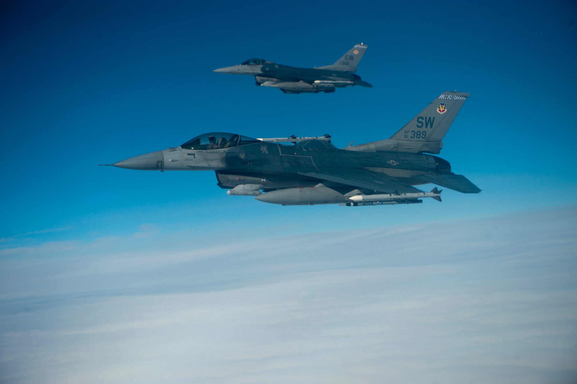 Two U.S. Air Force F-16s assigned to the 55th Fighter Squadron from Shaw Air Force Base, S.C., fly over the Nevada Test and Training Range during Red Flag 14-1, Feb. 6, 2014. Red Flag is a training exercise hosted at Nellis AFB, Nev., that provides realistic combat training missions for air and ground crews. These exercises improve combat readiness and effectiveness for future real-world conflicts or wars. (U.S. Air Force photo by Airman 1st Class Thomas Spangler)