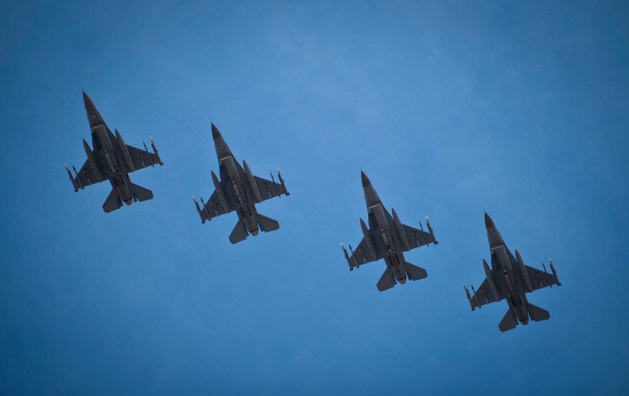 F-16 Fighting Falcons from the 140th Fighter Squadron, Buckley Air Force Base, Col., soar over Nellis Air Force Base, Nev., prior to landing at the end of a Red Flag 14-1 training mission Feb. 4, 2014. Aircraft and service members deploy to Nellis AFB for Red Flag under the Air Expeditionary Force concept and make up the exercise's "blue" forces.” By working together, these blue forces are able to use the diverse capabilities of their assets execute missions, such as air interdiction, combat search and rescue, close air support, dynamic targeting and defensive counter air. (U.S. Air Force photo by Airman 1st Class Joshua Kleinholz)