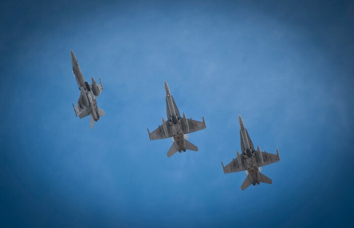 Three Royal Australian Air Force F/A-18 Hornets assigned to No. 77 Squadron, RAAF Base Williamtown soar over Nellis Air Force Base, Nev., prior to landing at the end of a Red Flag 14-1 training mission Feb. 4, 2014. Red Flag offers U.S. and coalition service members realistic combat training and is typically held three times a year. (U.S. Air Force photo by Airman 1st Class Joshua Kleinholz)