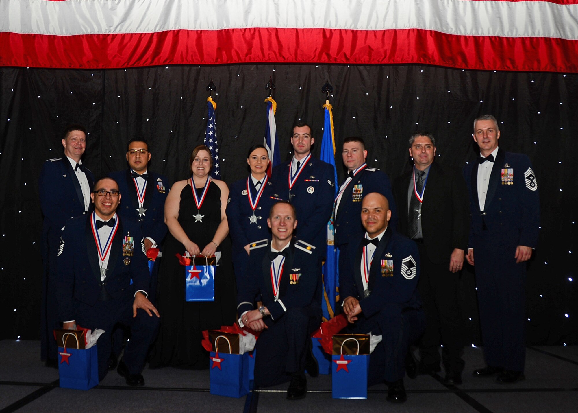 The 48th Fighter Wing’s top performers were recognized during the 2013 Annual Awards Banquet by Col. Kyle Robinson, 48th FW commander (far left), and Chief Master Sgt. Vincent Marler, 48th FW command chief (far right) at Royal Air Force Lakenheath, England, Feb. 8, 2014. Airmen were recognized across 11 categories, representing the spectrum of the 48th Fighter Wing, during the ceremony. (U.S. Air Force photo by Airman 1st Class Erin O’Shea)
