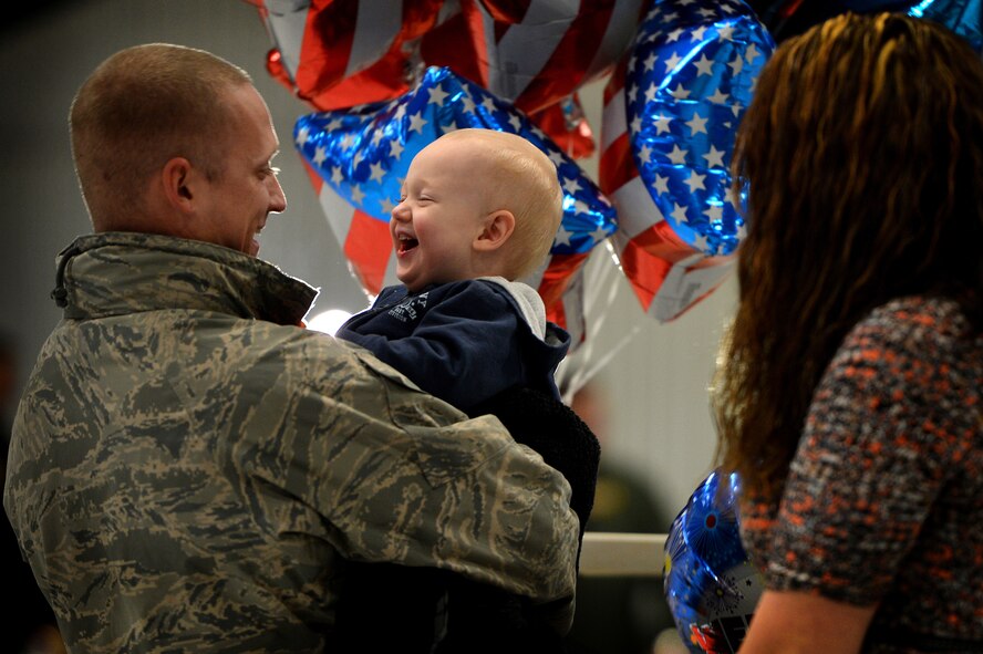 U.S. Air Force Senior Airman Ryan Bruhn, 79th Aircraft Maintenance Unit laughs with his son Hayden Bruhn after returning to Shaw Air Force Base, S.C., Feb. 7, 2014 from a five month deployment. Approximately 200 Team Shaw Airmen returned home from U.S. Central Command’s Area of Responsibility after completing their tour. (U.S. Air Force photo by Staff Sgt. Kenny Holston / Released)