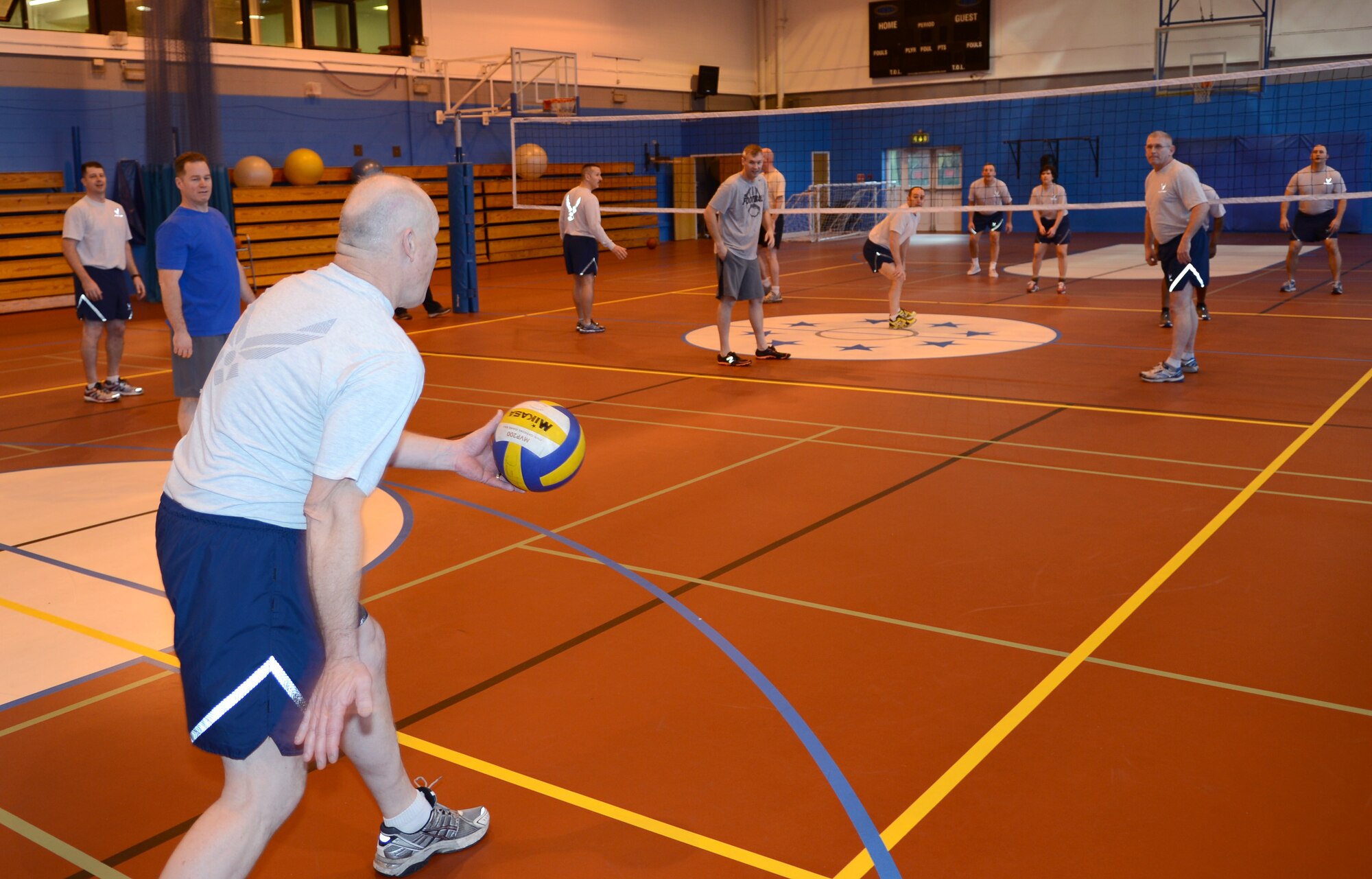 U.S. Air Force Chief Master Sgt. David Lee, 100th Maintenance Group chief from Charleston, W.V., serves a volleyball Feb. 7, 2014, during a “Chiefs vs. Eagles” volleyball game at the Northside Fitness Center sports day on RAF Mildenhall, England. Lee, along with other chief master sergeants on base, battled it out against the colonels on base for a “Chiefs vs. Eagles” trophy and bragging rights. The “Chiefs” came out on top, winning two games in a row and cementing their victory over the “Eagles” in the grand finale of the sports day. (U.S. Air Force photo by Airman 1st Class Dillon Johnston/Released)