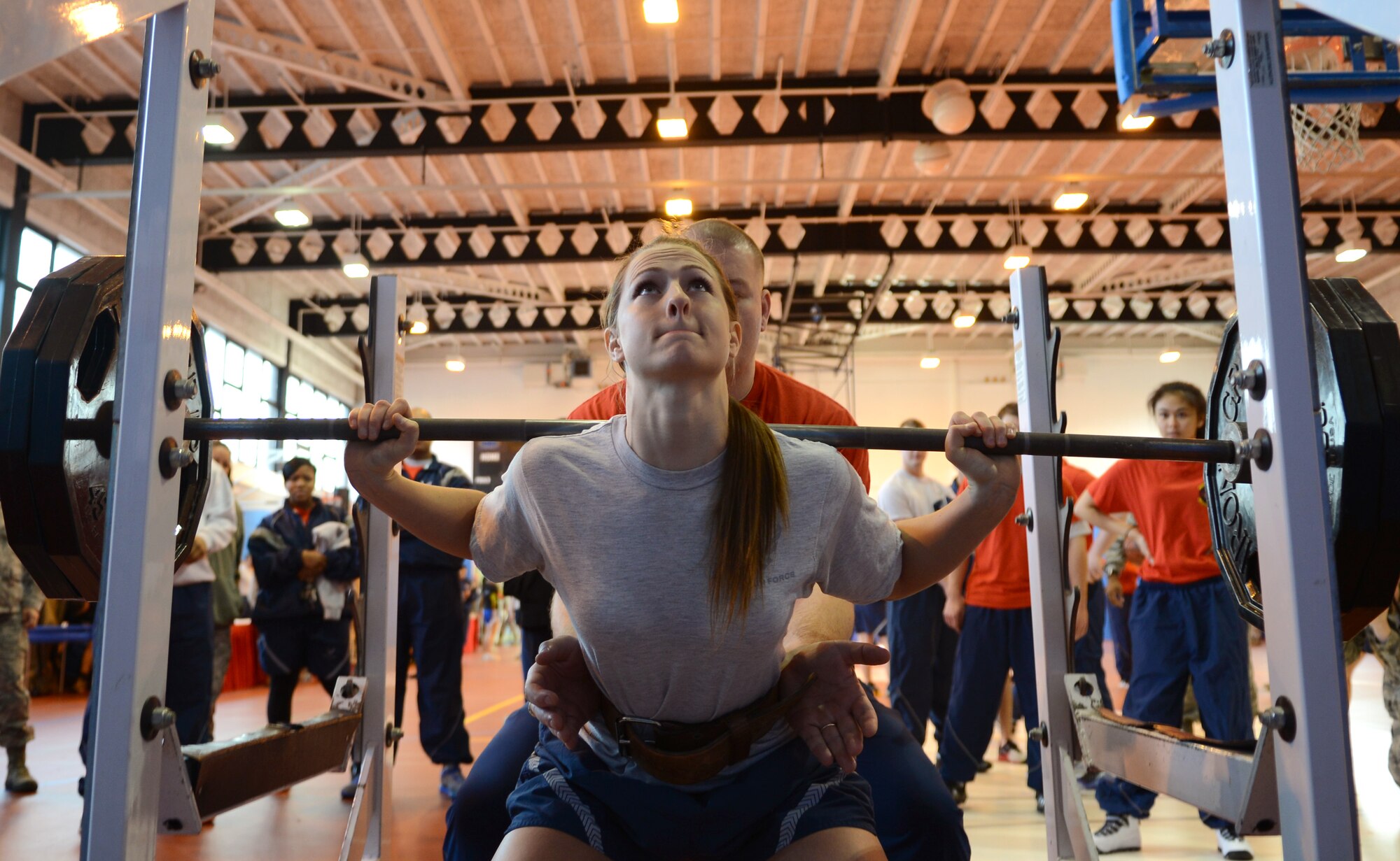 U.S. Air Force Airman 1st Class Addie Minnis, 100th Communications Squadron communications security accountant from Mebane, N.C., participates in a weighted squat competition Feb. 7, 2014, during the Northside Fitness Center sports day on RAF Mildenhall, England. Participants had three tries to squat as much weight as possible. Minnis came in second place after lifting 245 pounds. (U.S. Air Force photo by Airman 1st Class Dillon Johnston/Released)