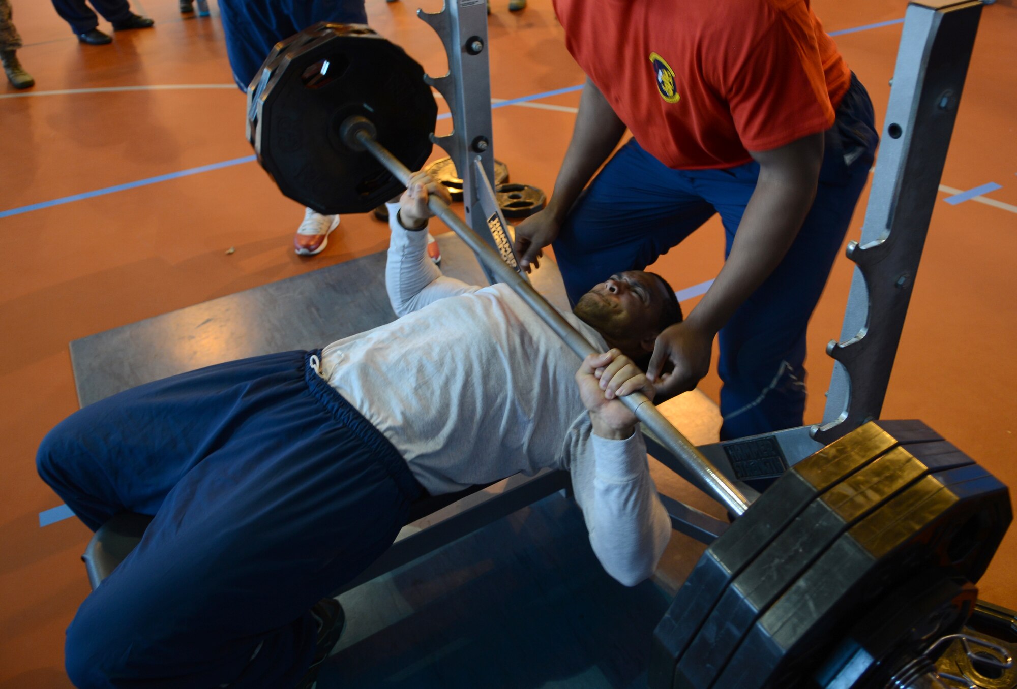 U.S. Air Force Staff Sgt. Justin Gray, 100th Force Support Squadron intramural sports director from Oakland, Calif., participates in a bench-press competition Feb. 7, 2014, during the Northside Fitness Center sports day on RAF Mildenhall, England. The day included multiple events which promoted fitness and camaraderie. Gray won the event after bench-pressing more than 300 pounds. (U.S. Air Force photo by Airman 1st Class Dillon Johnston/Released)