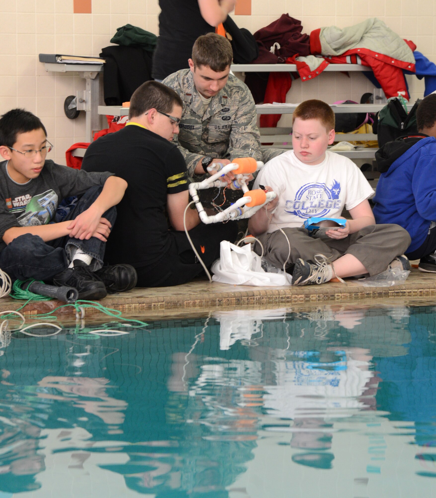 2nd Lt. Jeff Desroches, with the 423rd Supply Chain Management Squadron, helps Kyle Teel and Hunter Wood, both eighth graders, with their SeaPerch ROV.SeaPerch is an underwater robotics program that integrates Science, Technology, Engineering and Mathematics curriculum and pairs students with mentors to learn more about the STEM concepts. Students from Carl Albert Middle School and mentors from Tinker worked together with Starbase Oklahoma to make this character and career-building program successful.