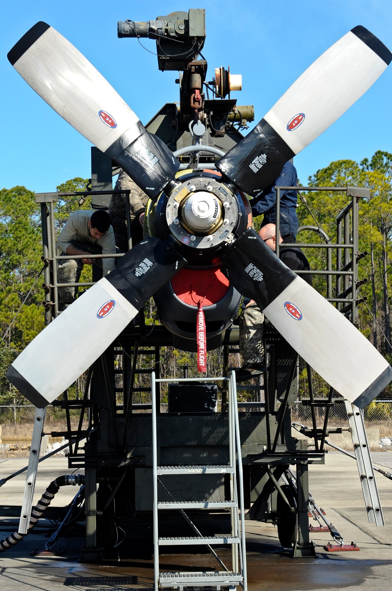 Airmen of the 1st Special Operations Component Maintenance Squadron work on an aircraft engine at the engine test cell on Hurlburt Field, Fla., Feb. 7, 2014. After repairing the engine, the Airmen conducted a performance check to assure the engine met limitation standards. (U.S. Air Force photo/Senior Airman Michelle Vickers)  