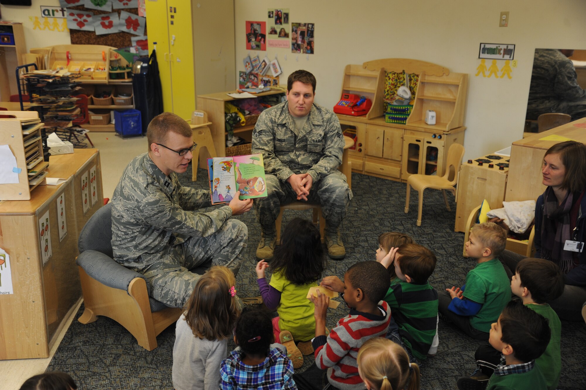 Capt. Brock Casperson, 92nd Aeromedical Dental Squadron dentist, reads Dr. Seuss’ “The Tooth Book” to children at Fairchild Air Force Base, Wash., Feb. 5, 2014.  The reading was part of a dental tour of the Child Development Center in honor of National Children’s Dental Health Month.  (U.S. Air Force photo by Airman 1st Class Sam Fogleman/Released)