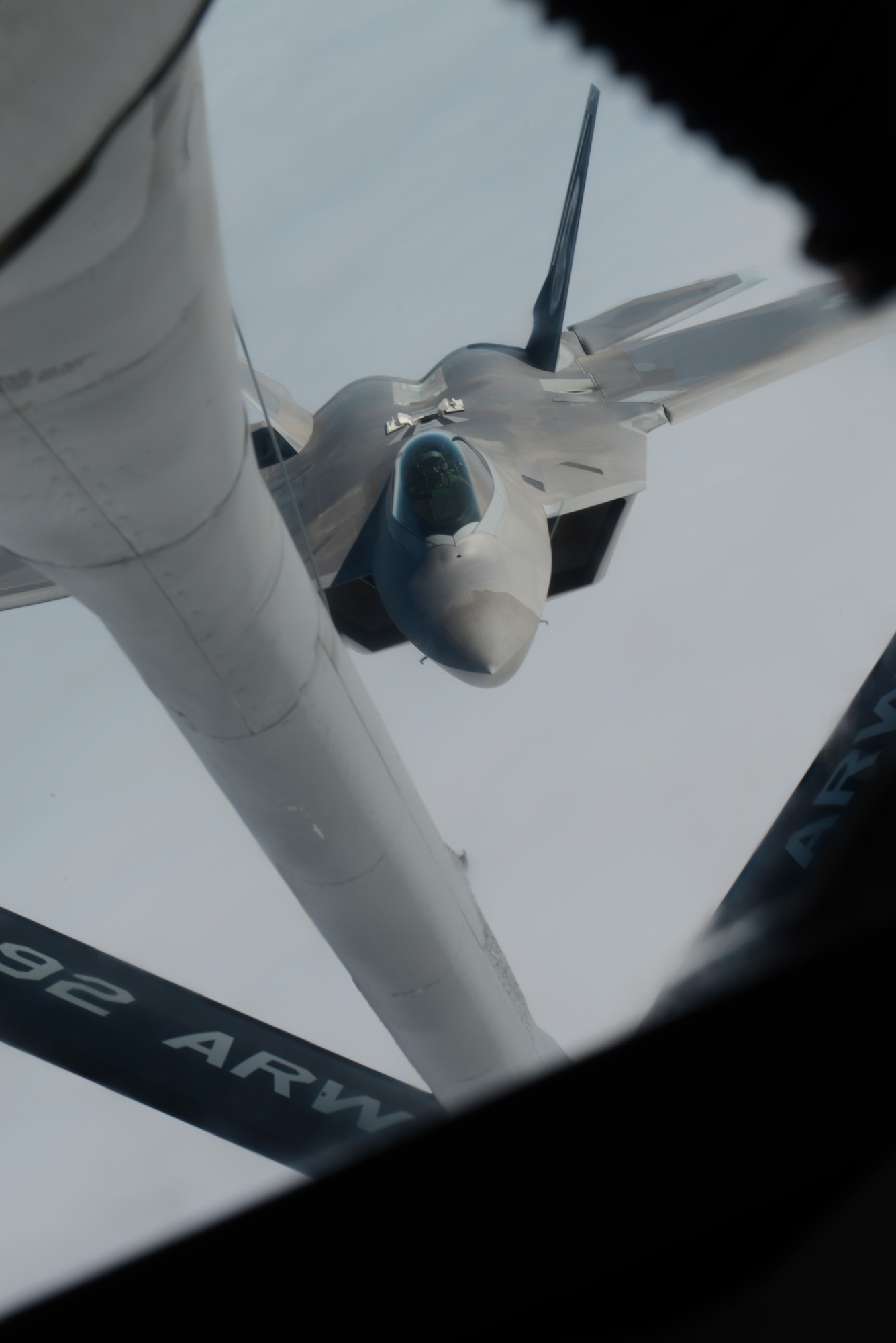 An F-22 Raptor from the 1st Fighter Wing, Joint Base Langley-Eustis, Va., prepares to refuel from a KC-135 Stratotanker from the 93rd Air Refueling Squadron Fairchild Air Force Base, Wash., over the Nevada Test and Training Range during Red Flag 14-1 at Nellis AFB, Nev., Feb. 6, 2014. Red Flag gives Airmen an opportunity to experience realistic, stressful combat situations in a controlled environment to increase their ability to complete missions and safely return home. (U.S. Air Force photo by Senior Airman Benjamin Sutton/Released)