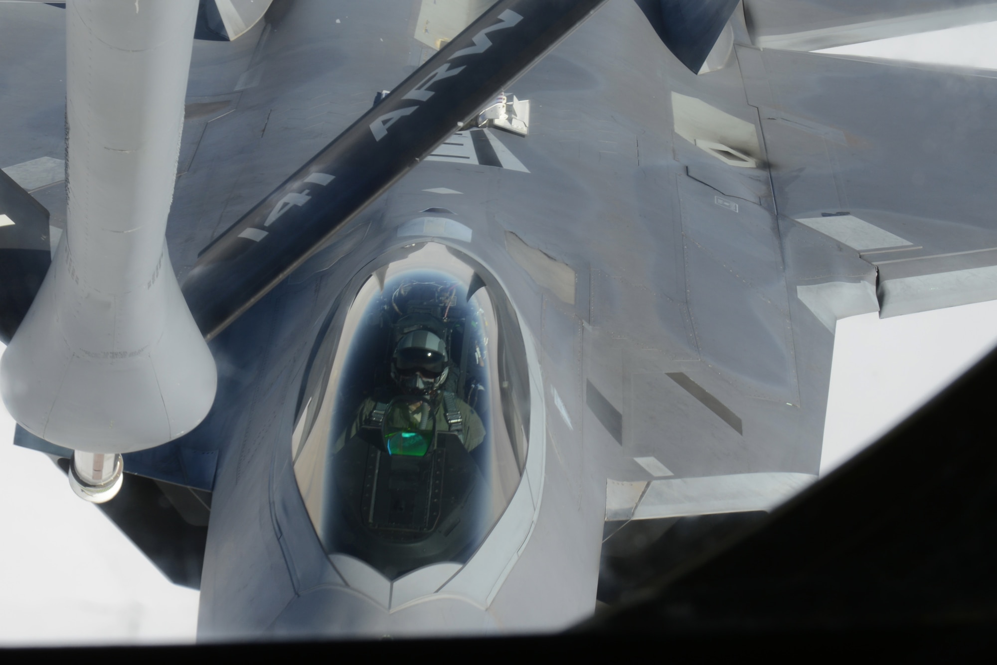 An F-22 Raptor from the 1st Fighter Wing, Joint Base Langley-Eustis, Va., closes in on the refueling boom Feb. 6, 2014, over the Nevada Test and Training Range. More than 20 units from across the globe are at Nellis Air Force Base, Nev., to participate in Red Flag 14-1. The Raptors were refueled by a KC-135 Stratotanker from the 93rd Air Refueling Squadron from Fairchild AFB, Wash. Since its establishment in 1975, Red Flag has played host to military units from more than 30 different countries. (U.S. Air Force photo by Senior Airman Benjamin Sutton/Released) 