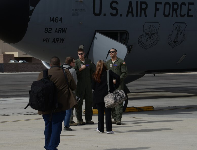 From left, Capt. Ben Martin, 93rd Air Refueling Squadron aircraft commander, and Airman 1st Class James Bloom-Kelly, 93rd ARS boom operator, both from Fairchild Air Force Base, Wash., welcome media before a flight Feb 6, 2014, at Nellis Air Force Base, Nev. More than 10 media representatives from around the world came to cover the combat exercise Red Flag 14-1. The exercise provides pilots with real-time war scenarios and helps their ground crews also test their readiness capabilities. (U.S. Air Force photo by Senior Airman Benjamin Sutton/Released)