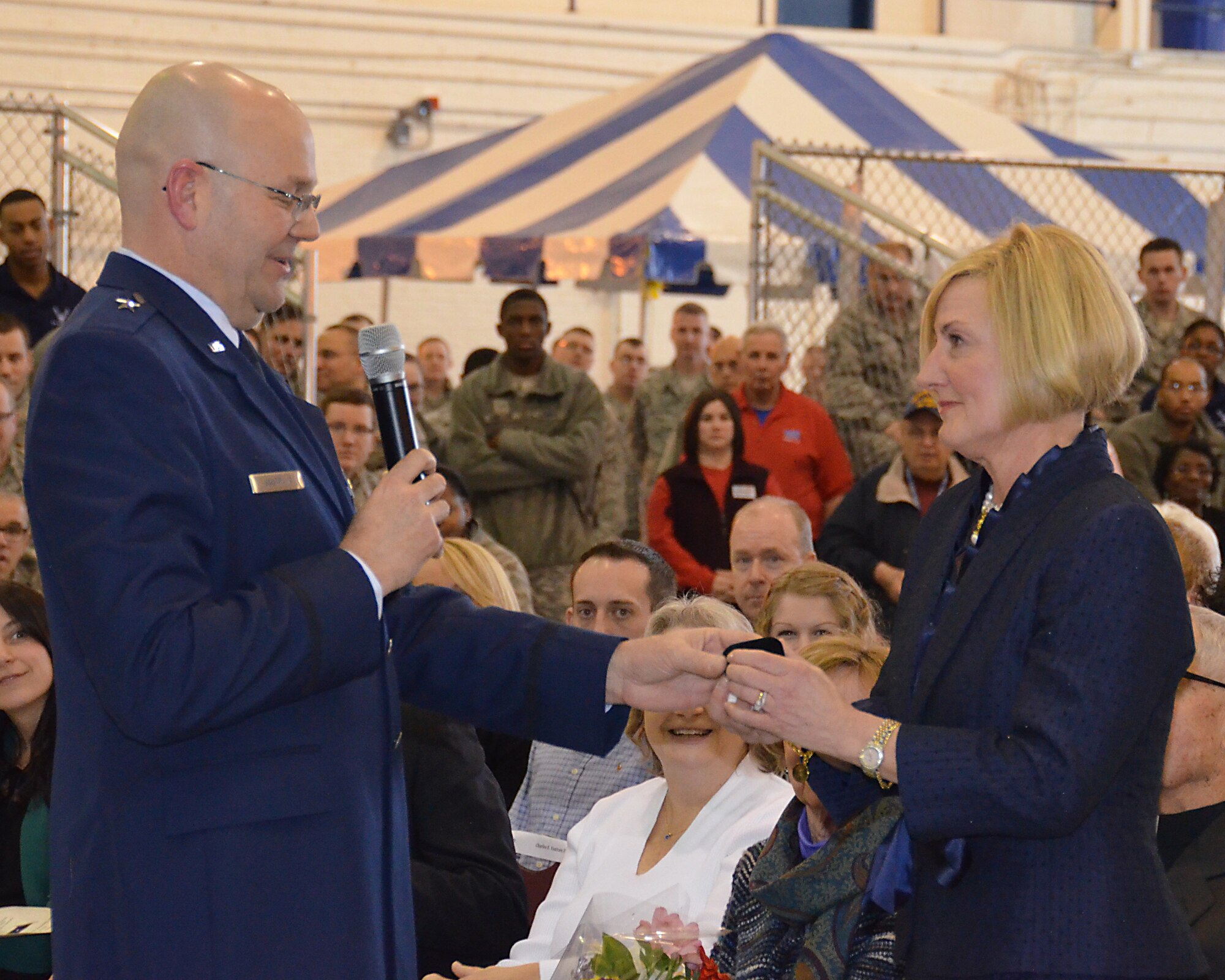 Brig. Gen. Steven Vautrain hands wife, Katie Vautrain, diamond earrings to show his gratitude for her years of support. (U.S. Air Force photo/SSgt. Kelly Goonan)