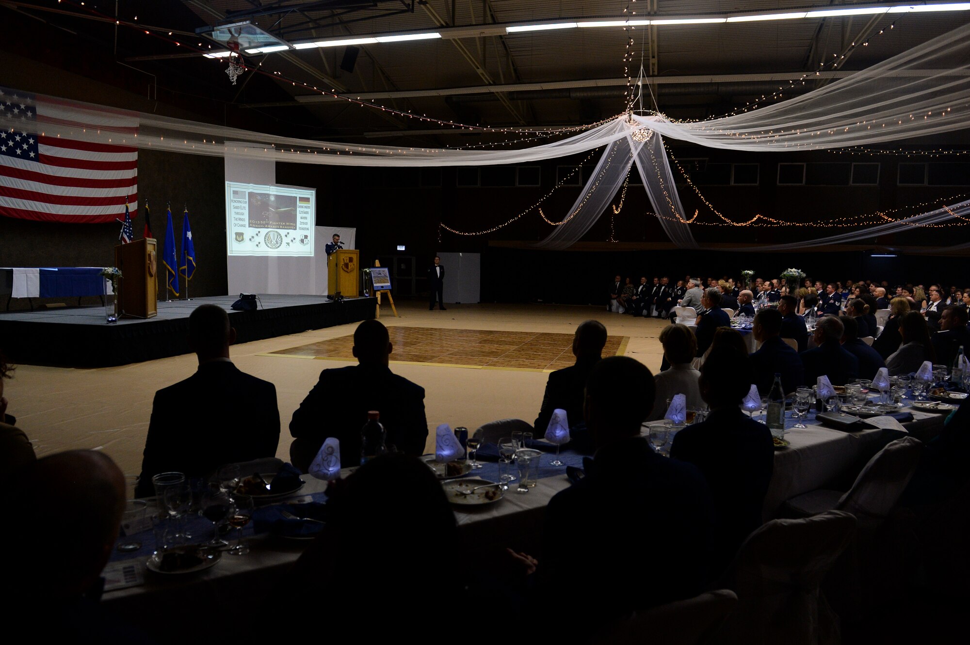 U.S. Air Force Col. David Julazadeh, 52nd Fighter Wing commander speaks during the Annual Awards Banquet, Feb. 8, 2014, at Spangdahlem Air Base, Germany. During his speech Julazadeh thanked all members of Saber Nation for their hard work throughout the year. (U.S. Air Force photo by Senior Airman Rusty Frank/Released)