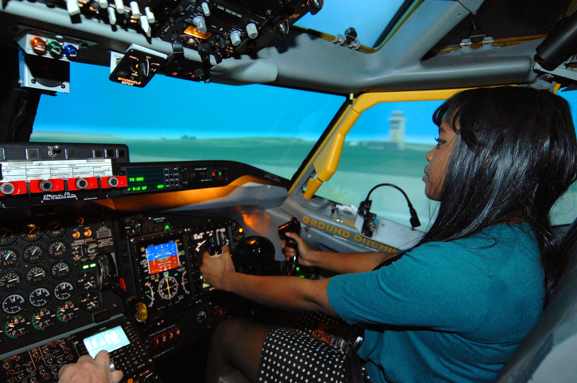 Dawnelle Brown, a Bellevue East High School student, pushes the yoke of an RC-135 flight simulator forward as she prepares to take off from a simulated runway at Offutt Air Force Base, Neb. Feb. 6. Brown was flying the simulator as part of the Offutt Flight Simulator Program that promotes education by inspiring students through experiences focused around science, technology, engineering and math. The program is sponsored by the Alfonza W. Davis chapter of Tuskegee Airmen Inc. (U.S. Air Force photo by Delanie Stafford/Released)