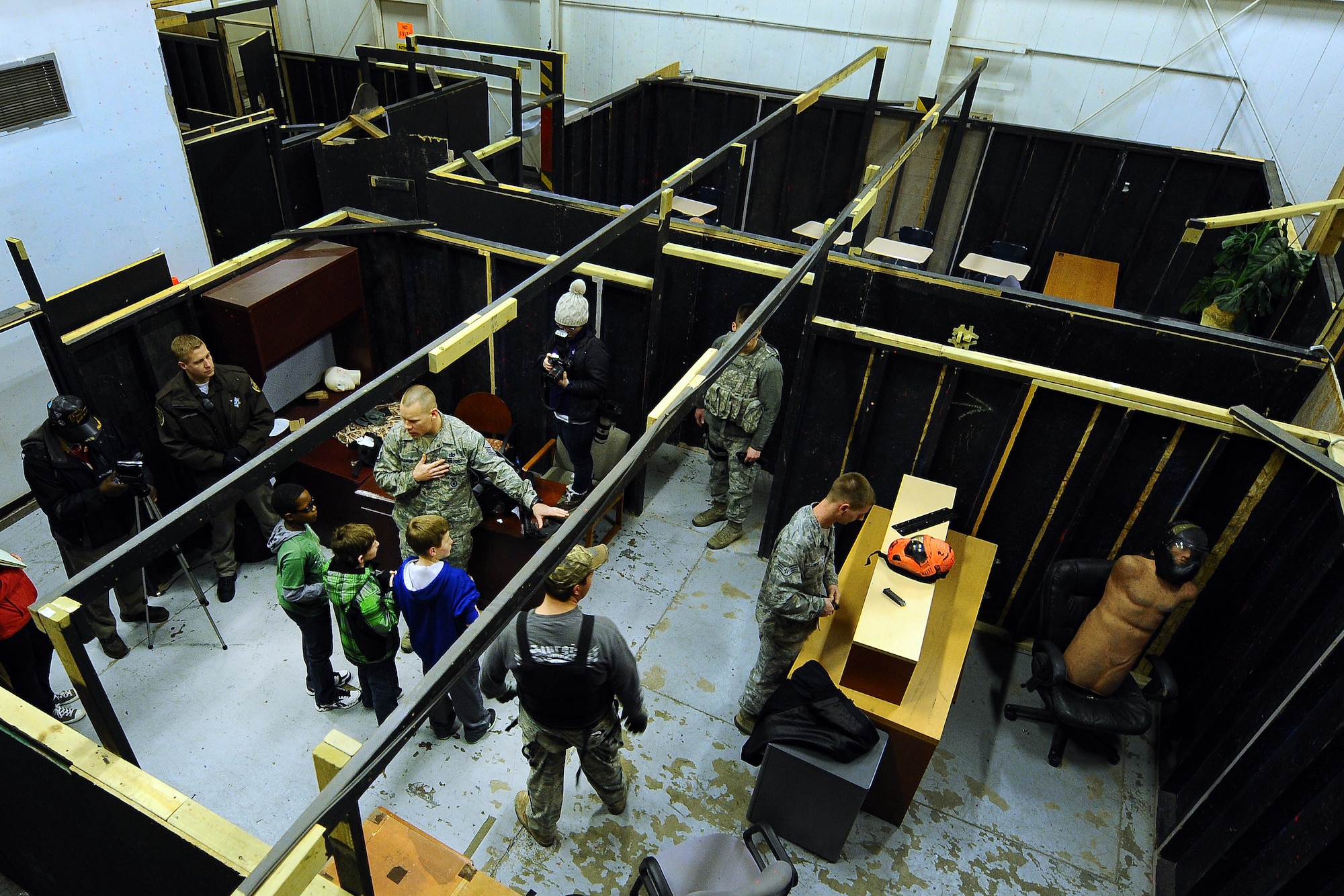 Members from the 55th Security Forces Squadron along with local law enforcement personnel give students from Alfonza W. Davis Middle School that is located in Omaha a tour of the security forces training facilities at Offutt Air Force Base, Neb. Feb. 3. The students visited Offutt as part of the Offutt Flight Simulator Program that promotes education by inspiring students through experiences focused around science, technology, engineering and math. The program is sponsored by the Alfonza W. Davis chapter of Tuskegee Airmen Inc. (U.S. Air Force photo by Joshua Plueger/Released)