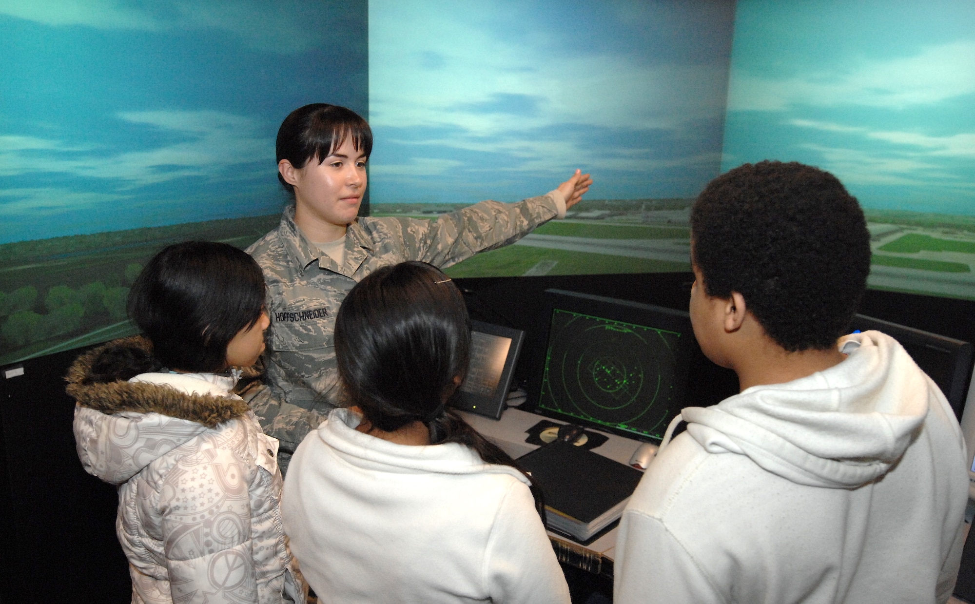 Senior Airman Corrine Hoffschneider, an air traffic controller from the 55th Operational Support Squadron, gives a tour of an air traffic simulator to students from the Alfonza W. Davis Middle School located in Omaha. The students toured the air traffic control tower at Offutt Air Force Base, Neb. on Feb. 3 as part of the Offutt Flight Simulator Program that promotes education by inspiring students through experiences focused around science, technology, engineering and math. The program is sponsored by the Alfonza W. Davis chapter of Tuskegee Airmen Inc. (U.S. Air Force photo by Delanie Stafford/Released)